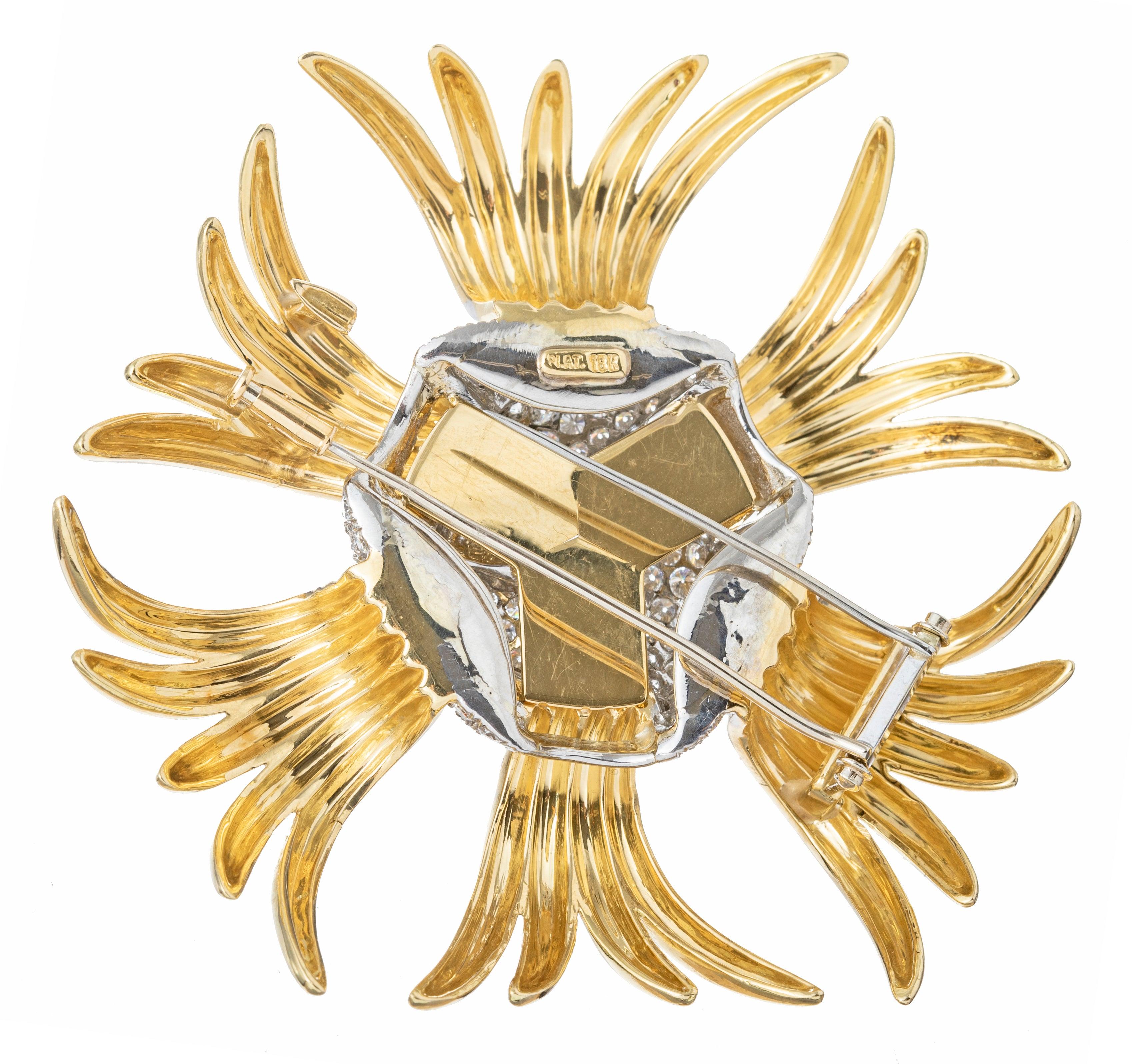 Large spray brooch, featuring high-polished 18k yellow gold radiating from a pave-set diamond knot motif at center in platinum.

120 round brilliant-cut diamonds weighing approximately 6.00 total carats.  Stamped 'PLAT' '18K'.  2.75