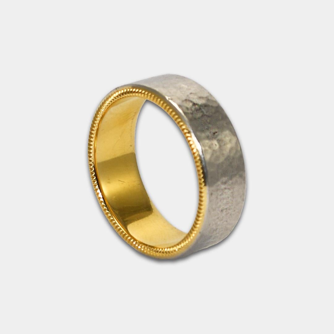 Men's designer wedding band.
Stamped perAmore 750AU, 950Pt.
The ring weighs 17.5 grams.
The top of the ring is platinum and has a hammer finish.
The sides and inside of the ring is 18k yellow gold.
The edges of the ring have a milled finish.
The