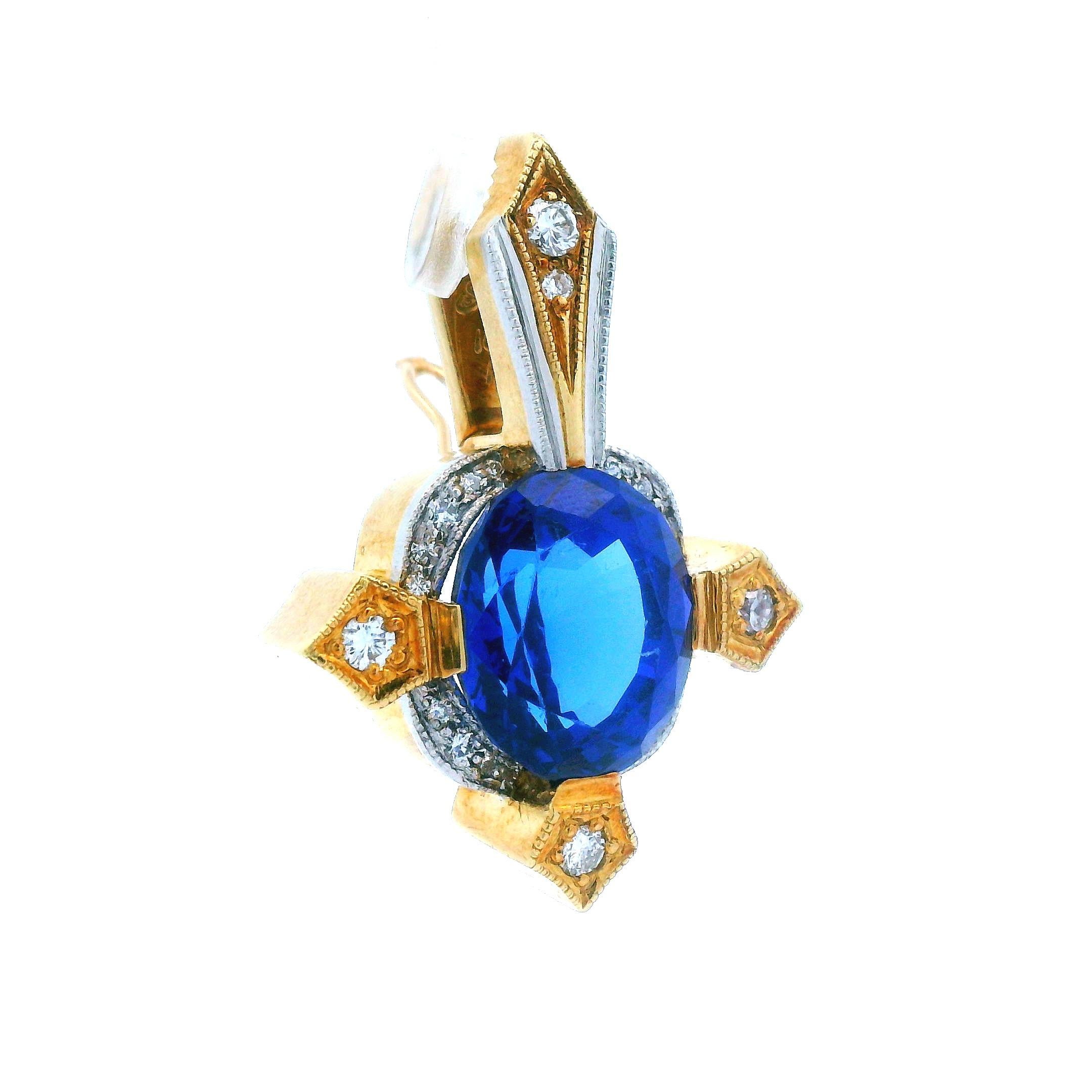 This 18k yellow gold and platinum pendant with tanzanite and diamond is extraordinary. Being made in rich, 18k yellow gold, and platinum, a forever white metal, this pendant exudes excellence. The center stone of this lovely pendant is a 10.00 ct,