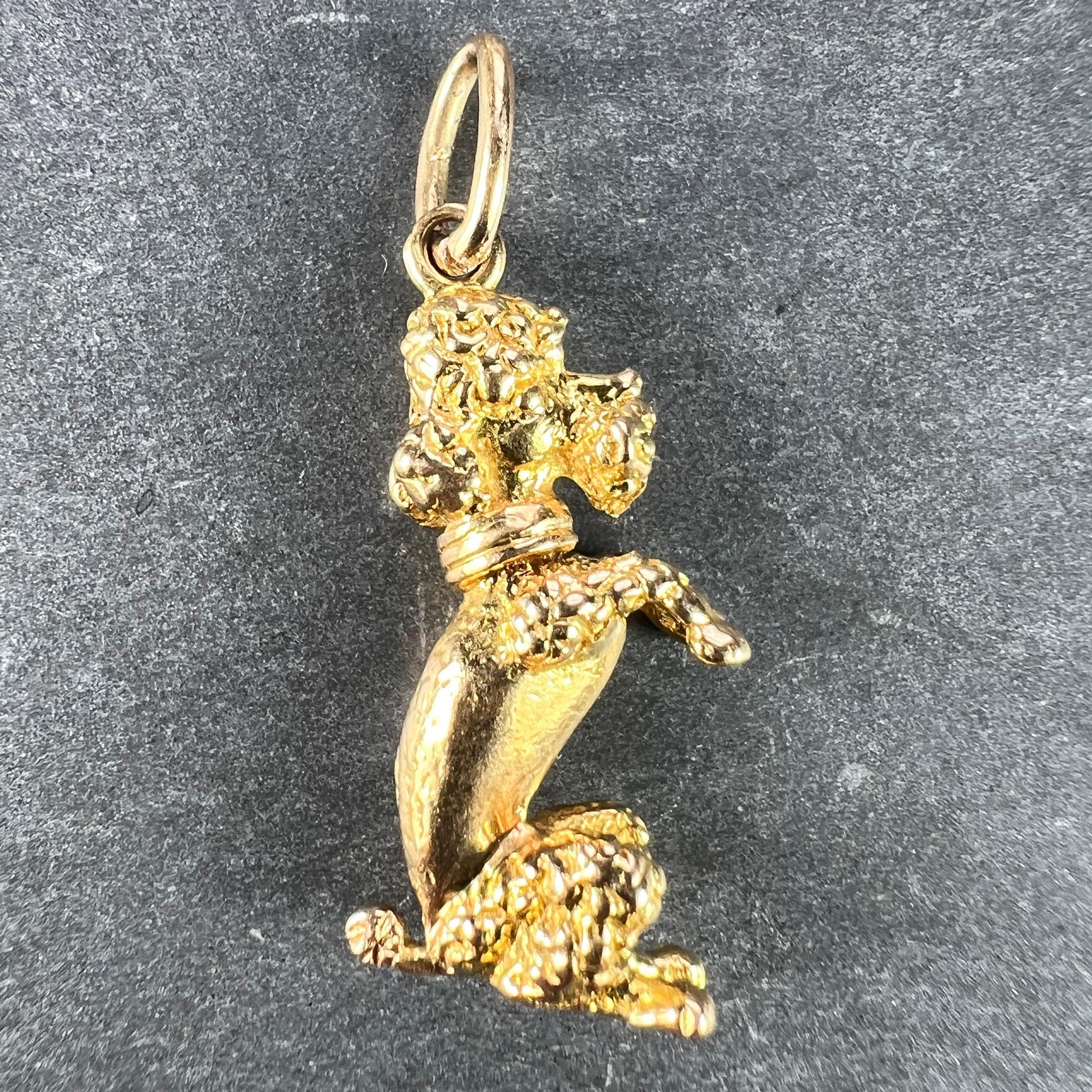 An 18 karat (18K) yellow gold charm pendant designed as a poodle dog sitting up on its haunches. Unmarked but tested for 18 karat gold.

Dimensions: 2.3 x 1 x 0.55 cm (not including jump ring)
Weight: 4.2 grams 
(Chain not included) 