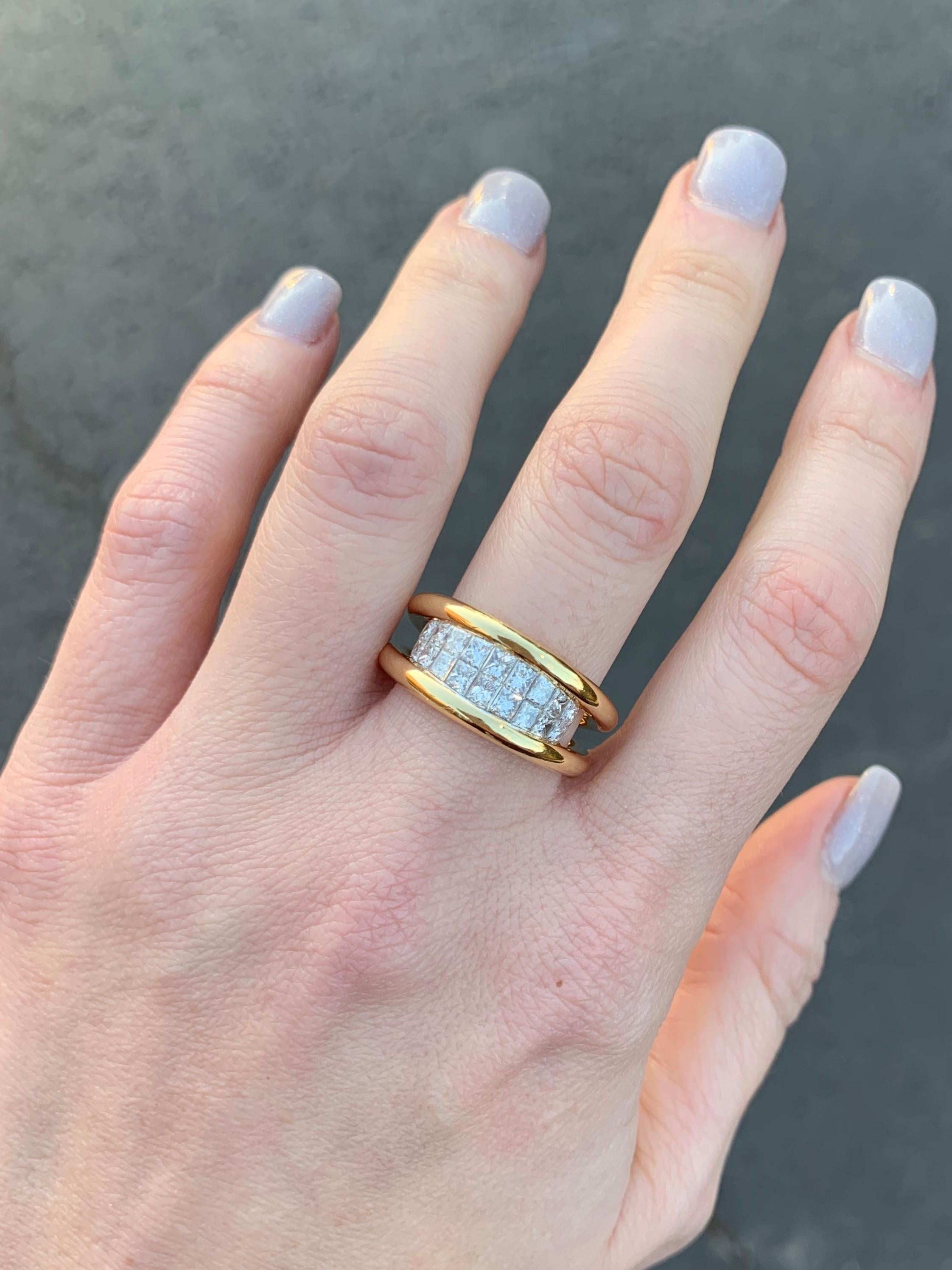 A very well made polished 18k yellow gold double shank modern ring featuring a center section of expertly invisibly set high quality princess cut diamonds. 18 Princess cut diamonds have a total weight of 1.02 carats at approximately G color, VS2-SI1