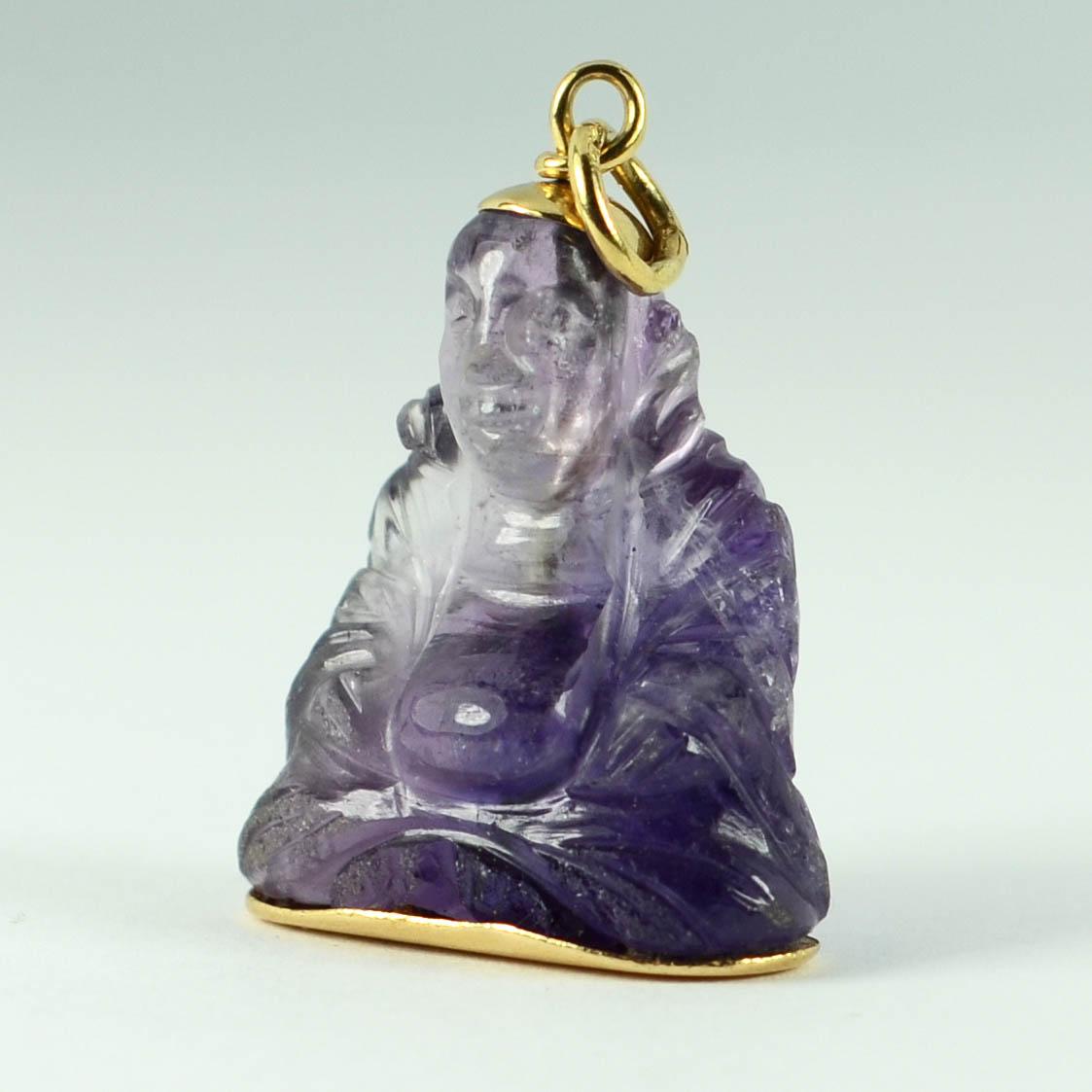 A charm pendant designed as a large carved Buddha sculpture in purple amethyst with 18 karat (18K) yellow gold terminals. Marked 750 to the jump ring for 18 karat gold.

Measurements: 3.1 x 2.2 x 1.4 cm (not including jump ring)
Weight: 8.68 grams