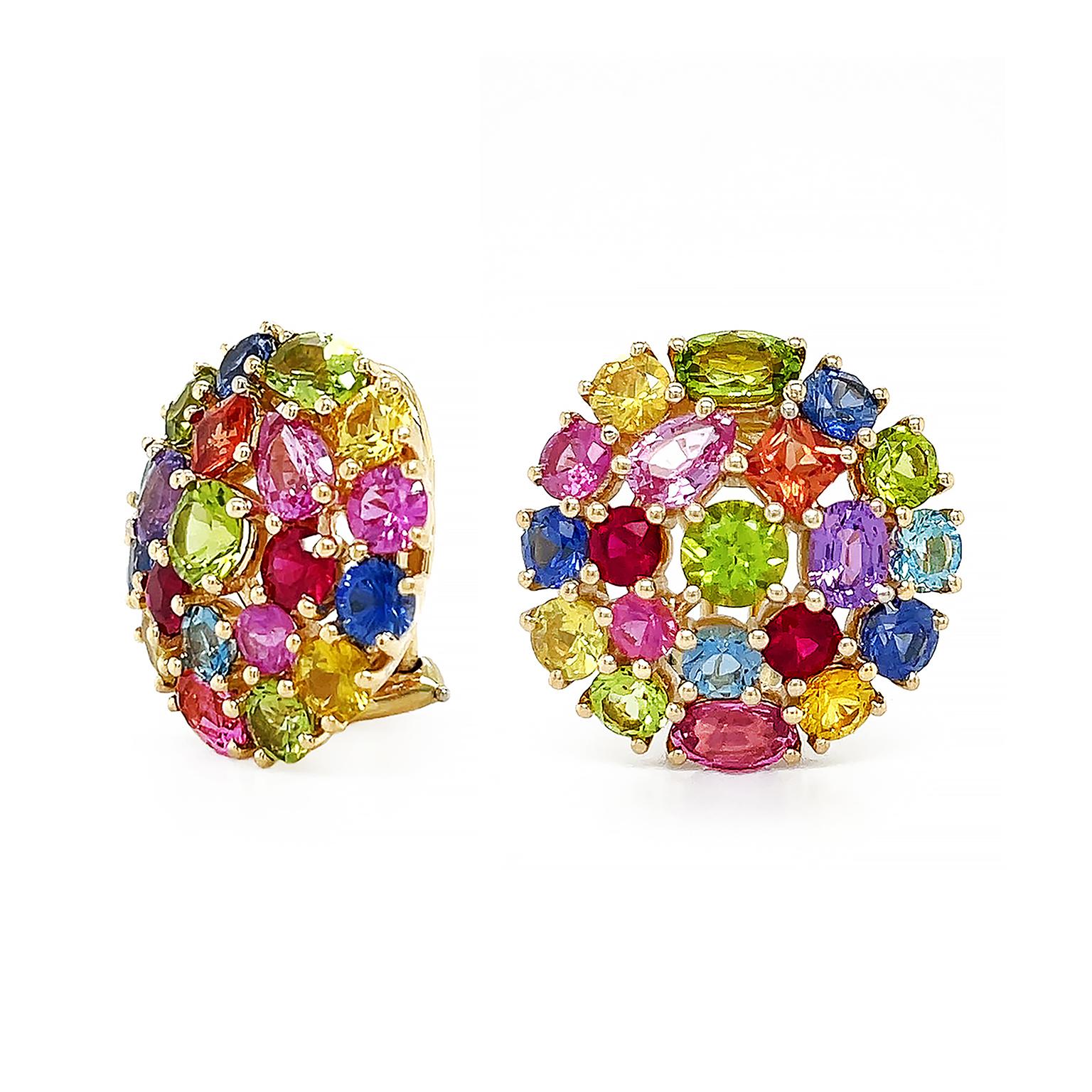 A polychromatic dance of precious and semi-precious gems orbits these earrings. Sapphire, ruby, peridot, and aquamarine are the gemstones of choice. Varied shapes of oval, pear, princess, and round provide an intriguing collage while enhancing the