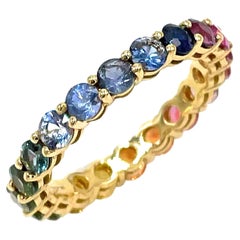 Anello Eternità con zaffiro arcobaleno in oro giallo 18K