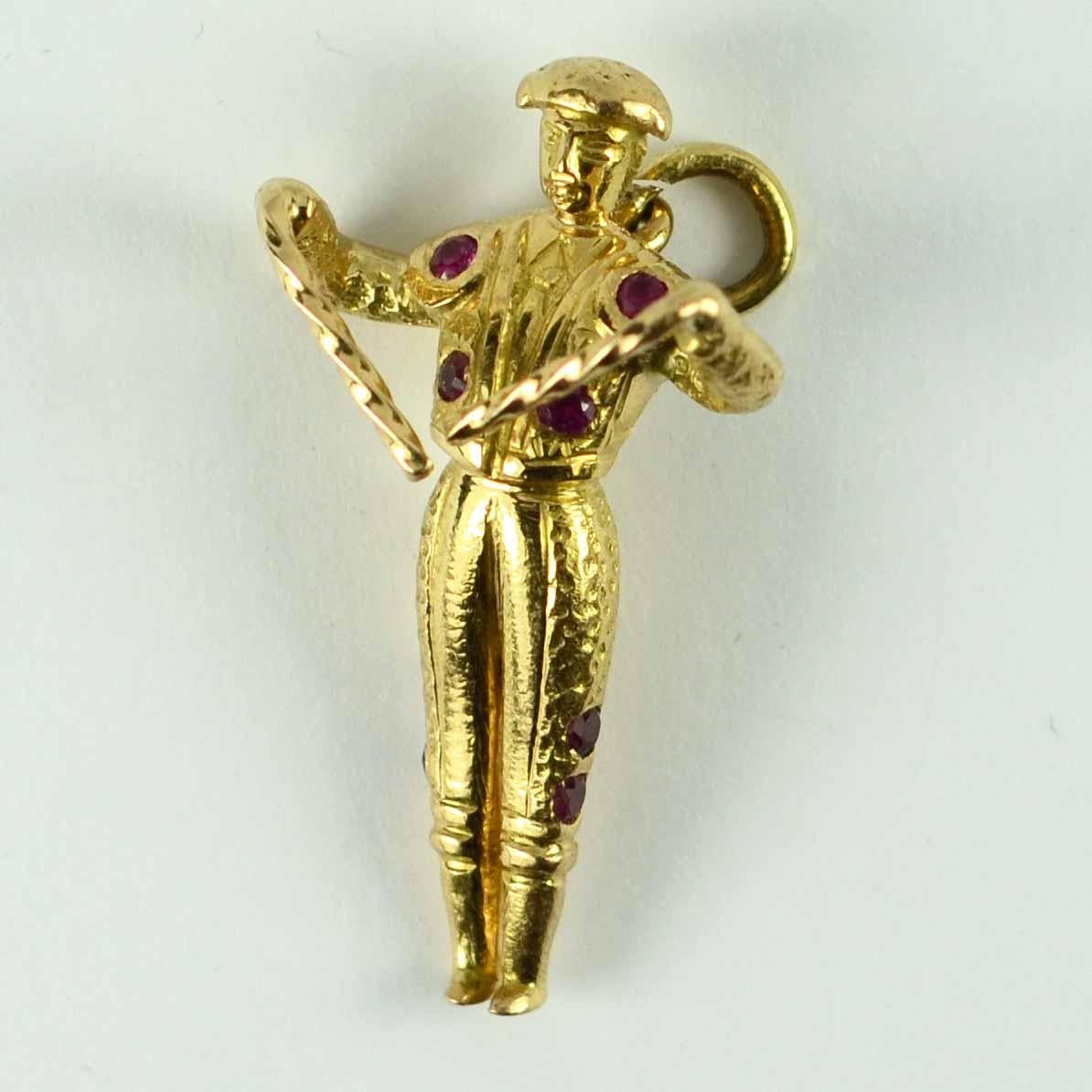 An 18 karat (18K) yellow gold and ruby charm pendant designed as a Spanish Matador or bull fighter from Spain, set with 13 round cut red rubies with a total approximate weight of 0.52 carats. Unmarked but tested for 18 karat gold.

Dimensions: 3.3 x