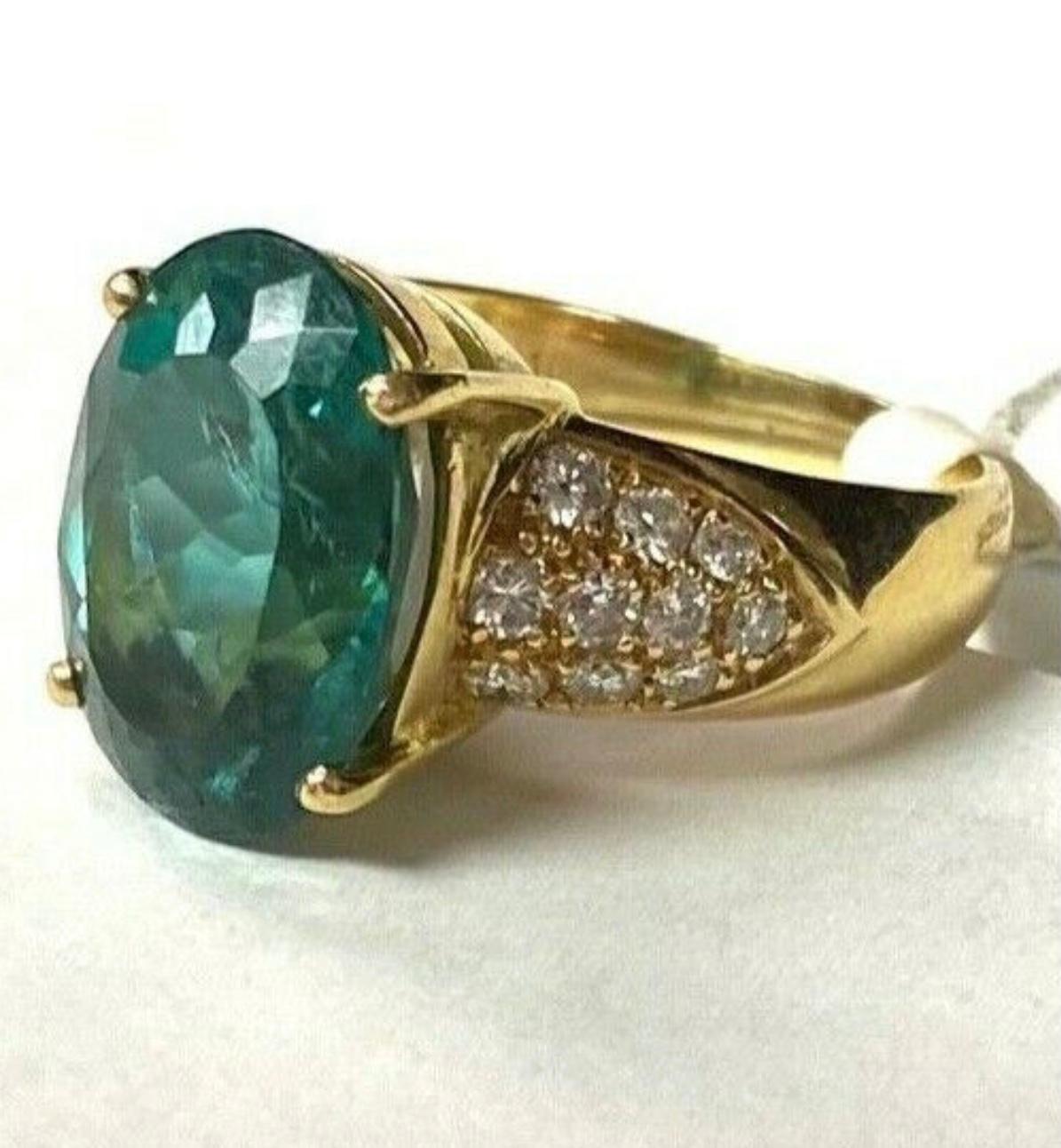 18k yellow Rare Green Topaz ring. The dimensions of the Topaz are approximately 14.95 mm x 9.5 mm each. Approximately 5 carats. Marked 18k. Approximate ring size 6.5.
