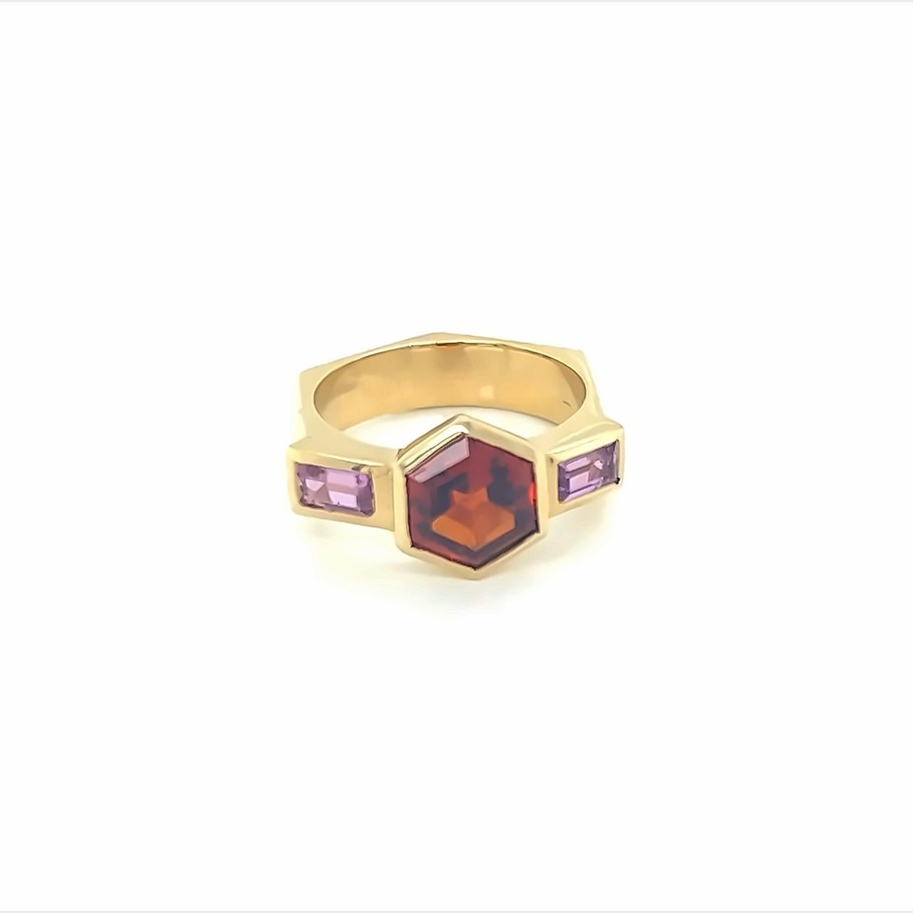 18k yellow gold ring with hexagon spessartite (orange garnet) and pink tourmaline baguettes.
