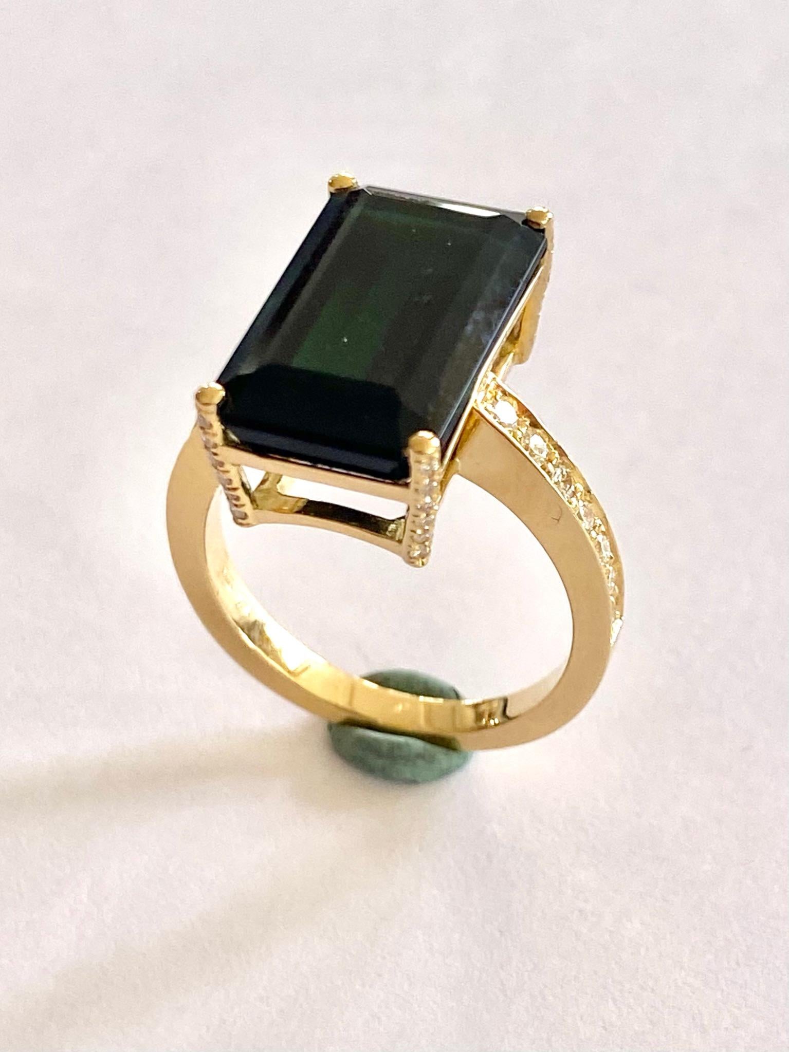 One 18K. Yellow Gold Ring 
1 One natural Tourmaline, Verdelite = Dark Green  = 9.00 ct.  (No Treatment)
38 Natural Diamonds, briljant cut = 0.36 ct.   VVS- F/G
size: 17.5 (55)  USA: 7.25  UK: O
Weight:  6.83 grams
Handmade ring