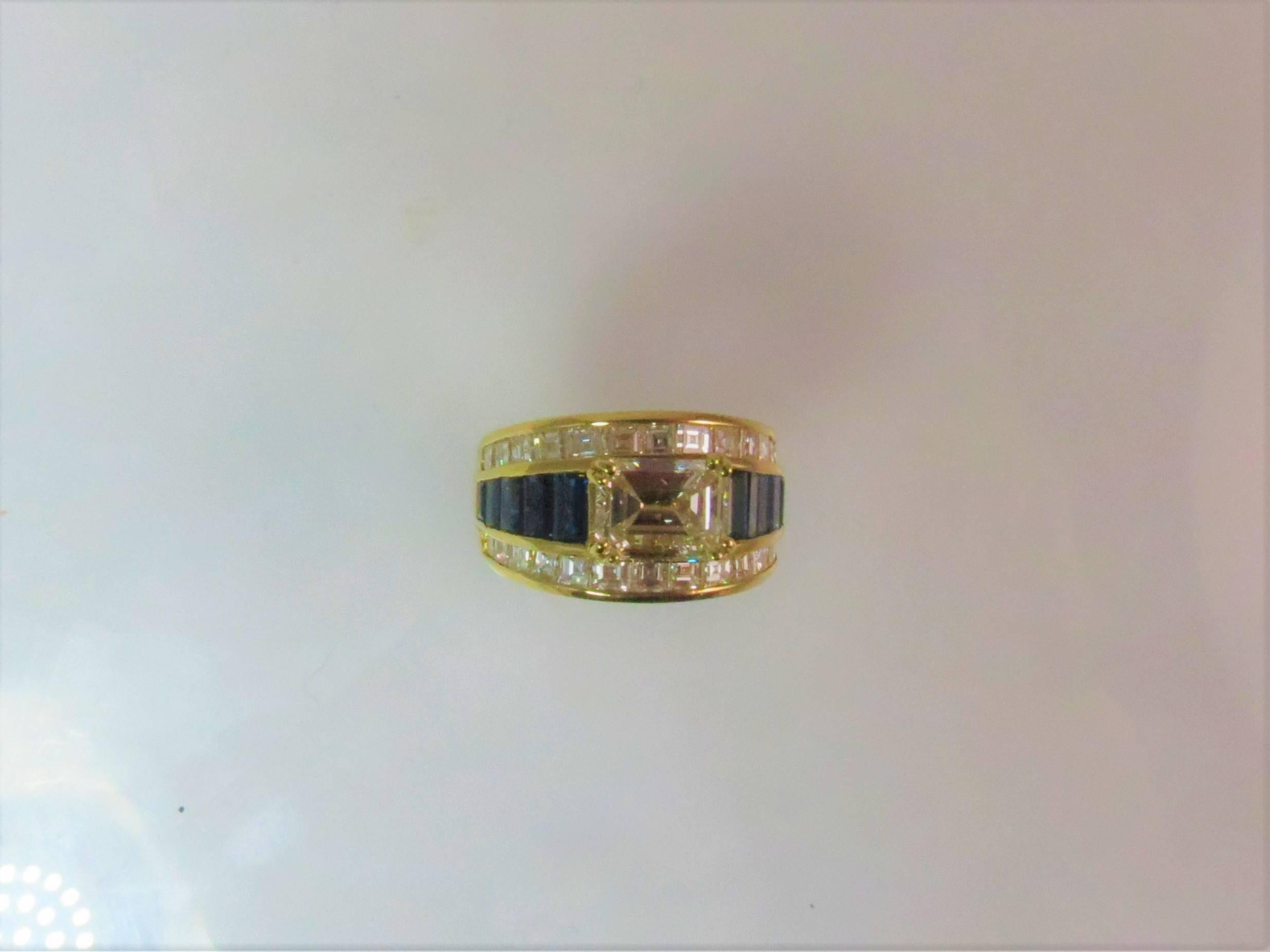 Contemporary 18K Yellow Gold Ring With 1.87ct Emerald Cut Diamond and Diamonds and Sapphires For Sale