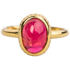18k Yellow Gold Ring with an Oval Red Tourmaline Cabochon and White Diamonds