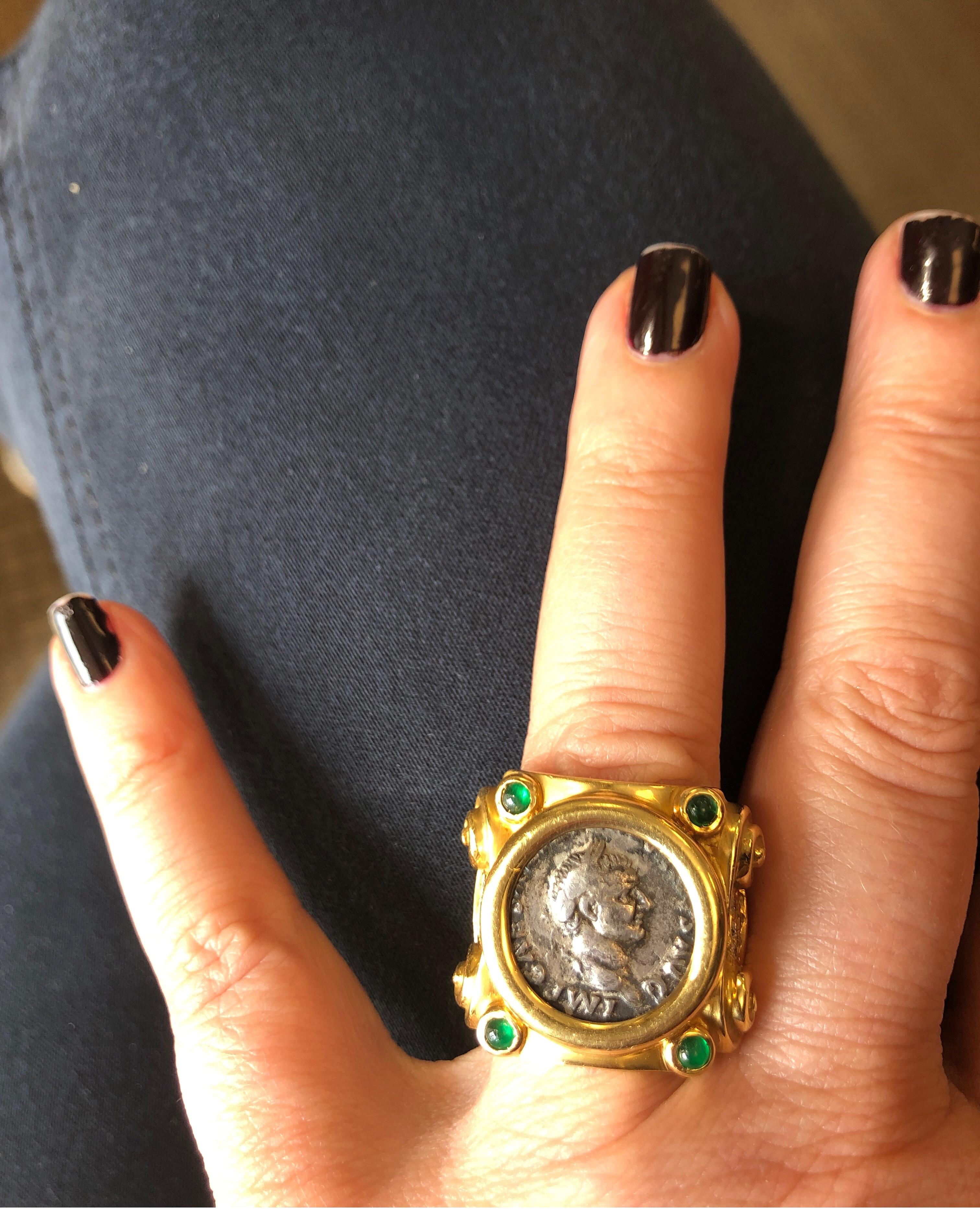 18K yellow gold ring with ancient silver Roman coin and 12 round diamonds weighing .22cts and 4 cabachon emeralds. Weighs 18.2 grams
Finger size 5.5. May be sized