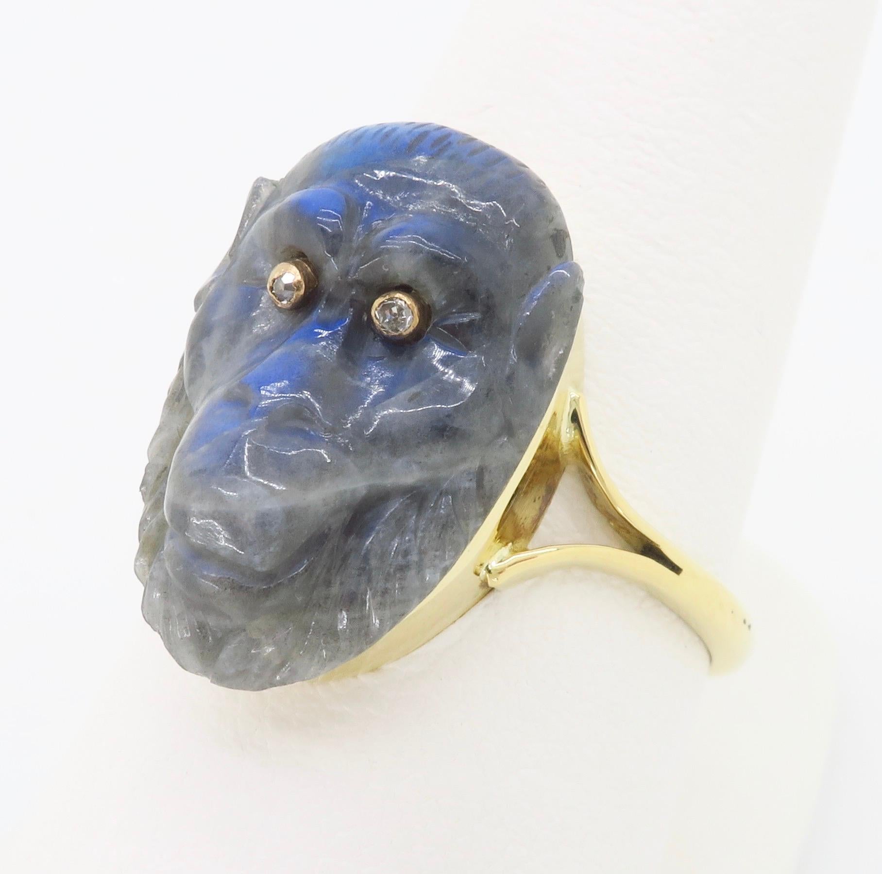 One-of-a-kind carved Labradorite Gorilla, with incredible play of color, with diamond eyes set into an 18k yellow gold ring.

Gemstone: Labradorite & Diamond
Diamond Carat Weight:  Approximately .05CTW
Diamond Cut: Single Cut Round
Metal: Yellow