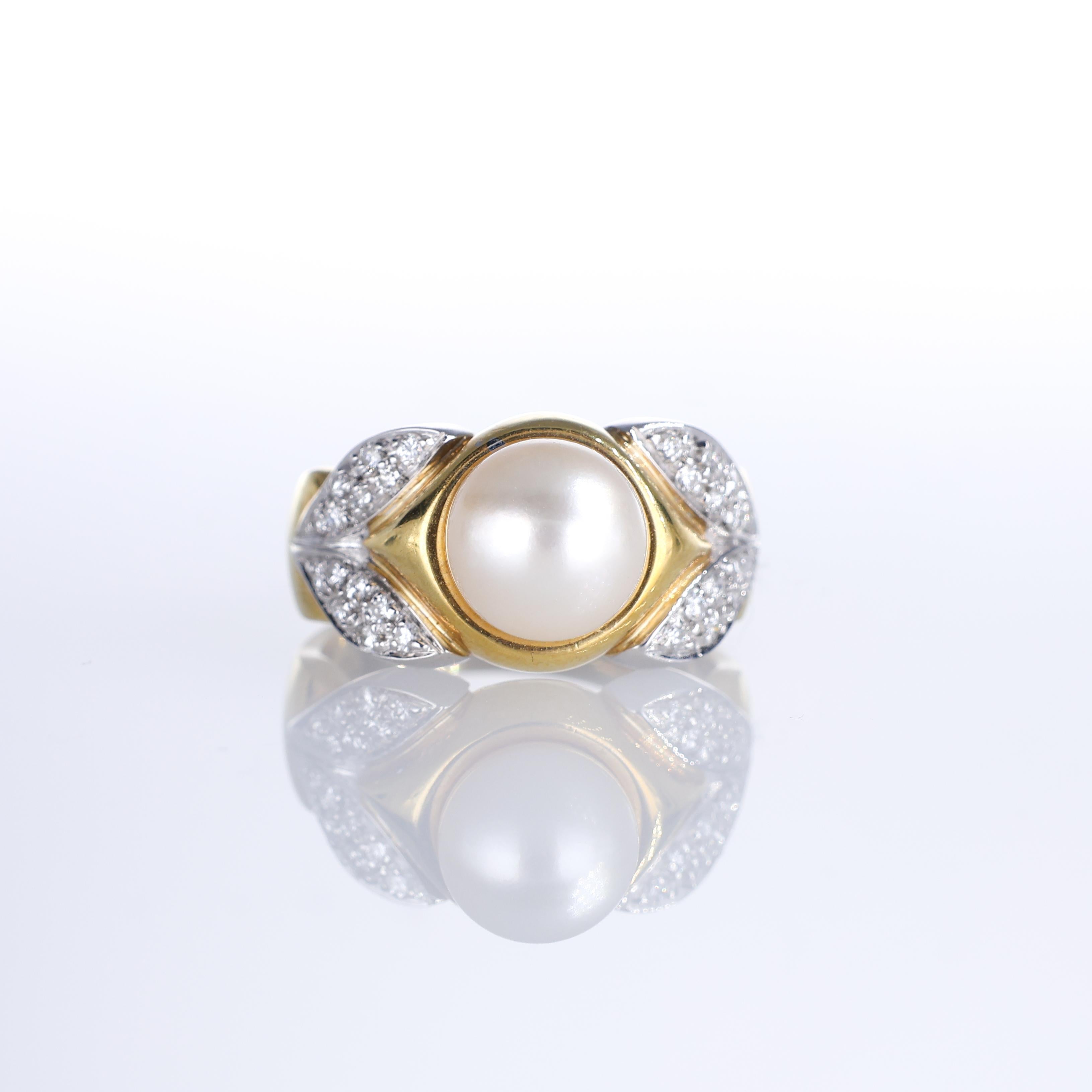 A refined 18K yellow gold ring featuring a luminous 8mm central pearl, embraced by delicately crafted leaf motifs in pavé diamonds, totaling 0.36 carats. The harmonious blend of gold, pearl, and diamonds makes this piece an embodiment of timeless
