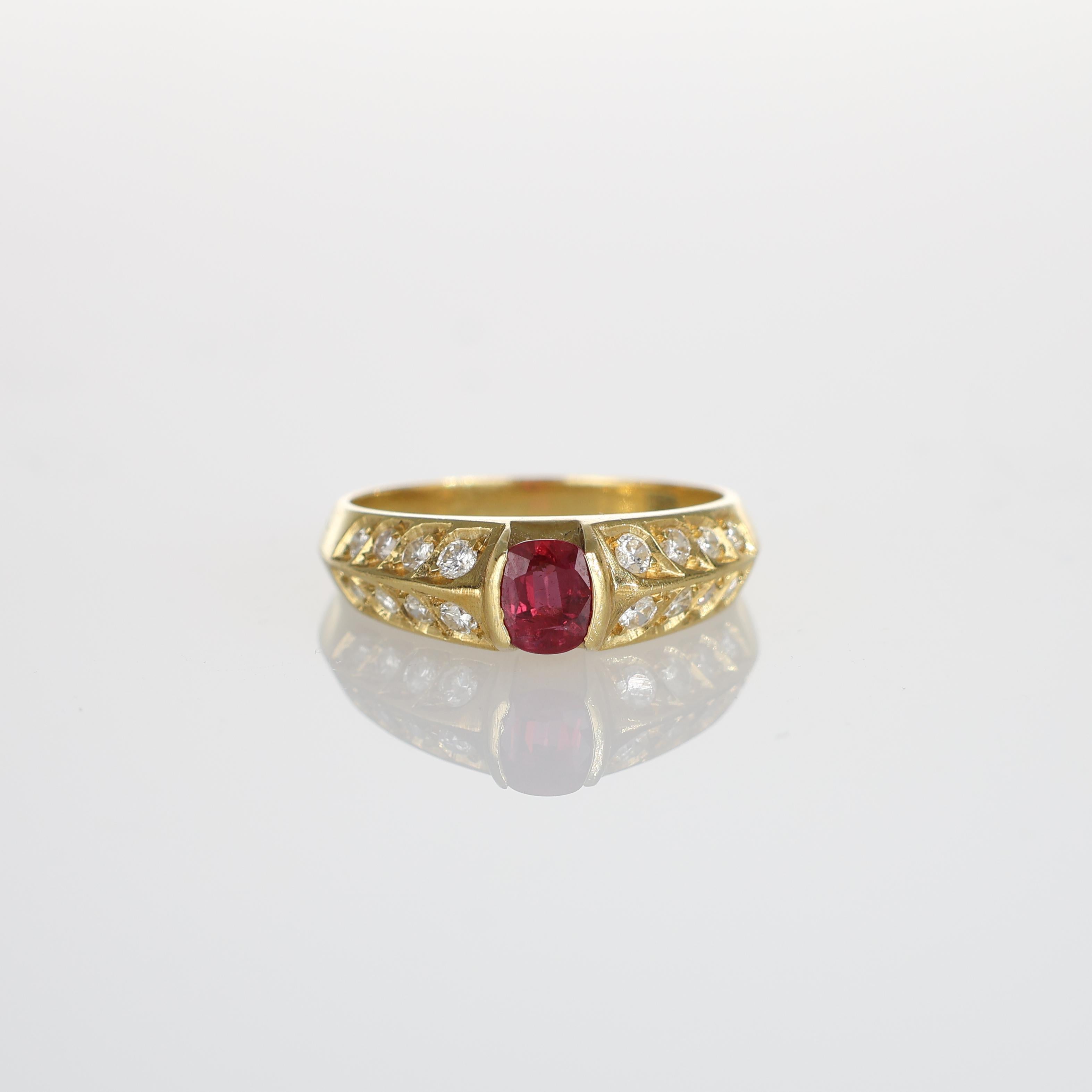 A striking 18k yellow gold ring featuring a vivid central ruby complemented by 16 brilliant-cut diamonds on the sides. The refined design combines the warmth of yellow gold with the elegance of vibrant gemstones, creating a timeless and versatile