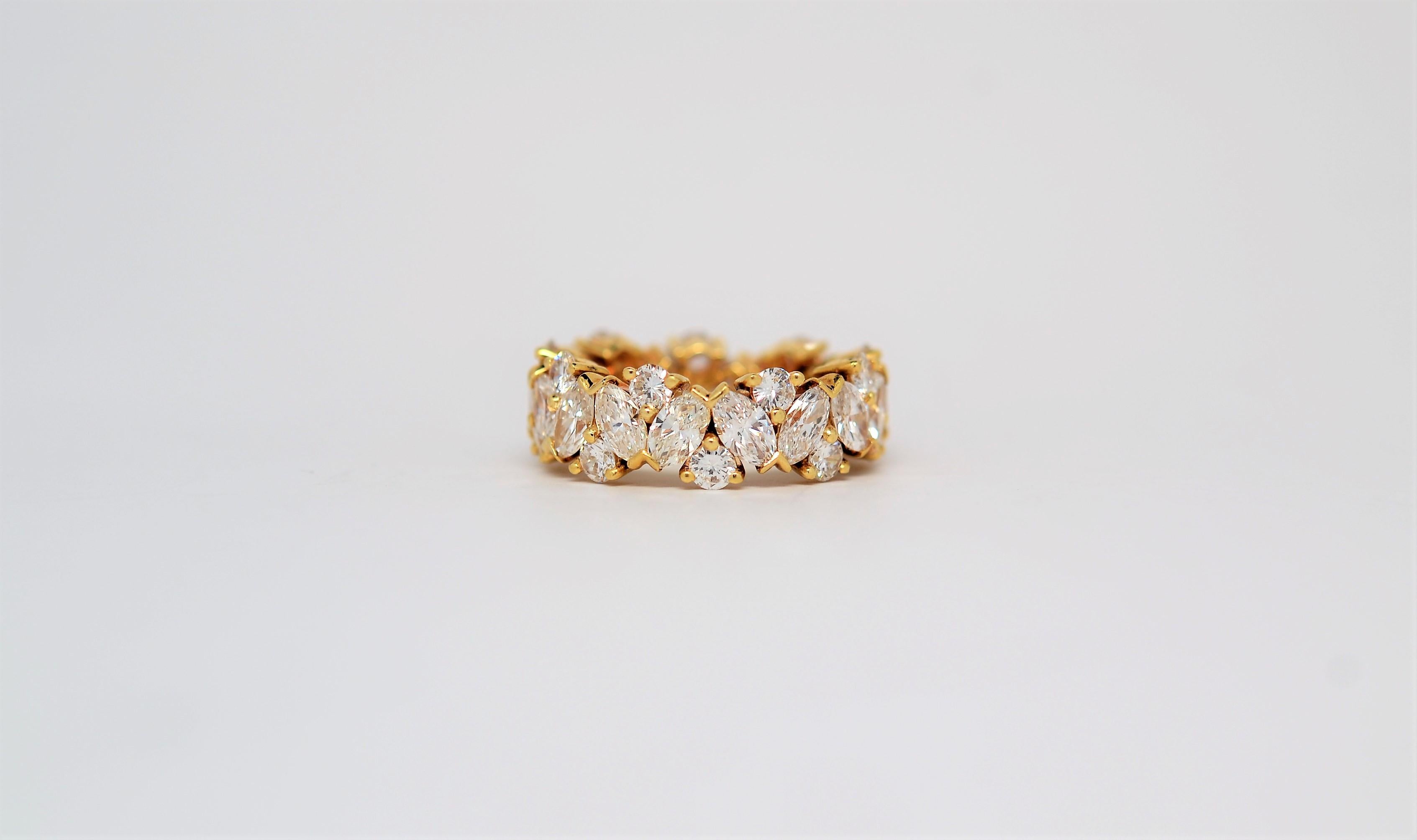 A finely crafted and handmade 18K Yellow Gold Ring set with Marquise Brilliant Cut and Round Brilliant Cut Diamonds. The ring is set all the way around in an eternity layout with offset Marquise Brilliant Cut Diamonds using shared Chevron tips.