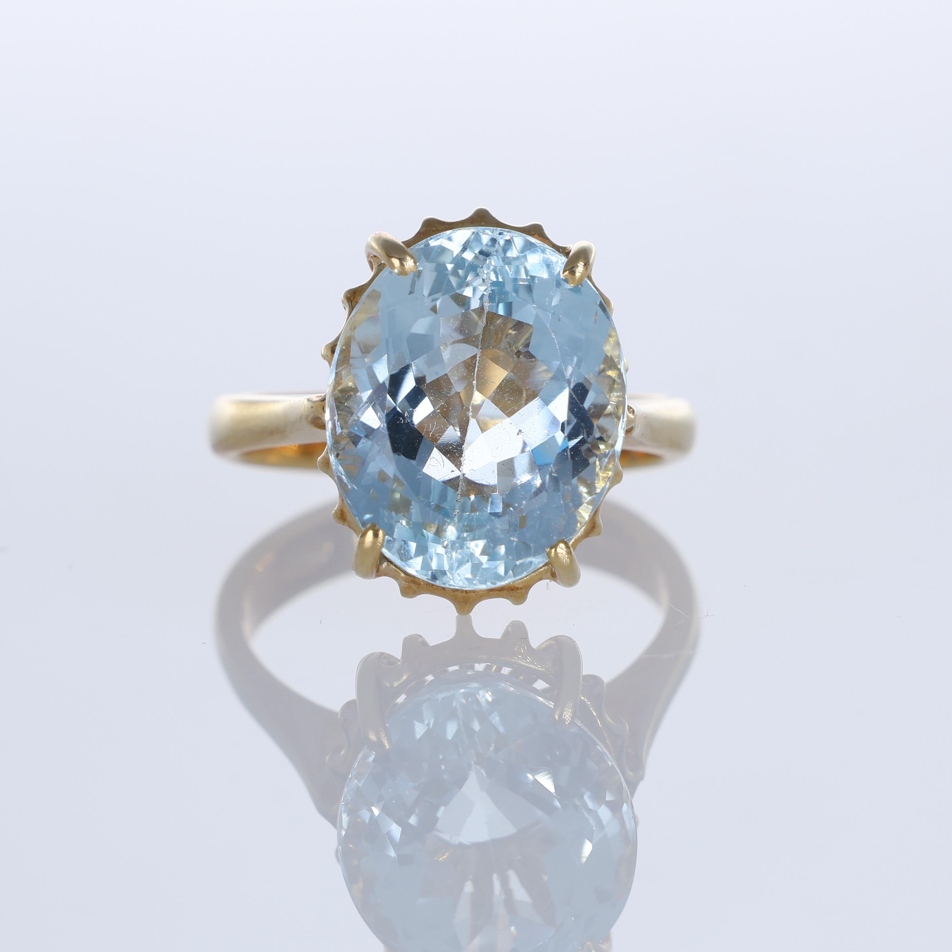 A refined 18K yellow gold ring showcasing an impressive 6.26-carat oval-cut aquamarine. The delicate prong setting enhances the gemstone’s brilliance, allowing light to pass through and highlight its serene blue tones. A timeless piece that exudes
