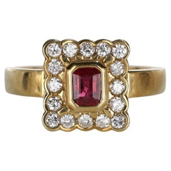 Anello in oro giallo 18k con rubino taglio rettangolare e diamante naturale aureolato