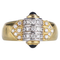 Anello in oro giallo 18k con cilindro in oro bianco, diamanti e zaffiri