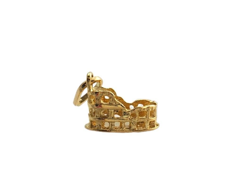 Vintage 18K yellow gold Rome Colosseum charm -

This intricate charm depicts the historical Rome Colosseum and is set in beautifully detailed 18K yellow gold.

Size: 14.21mm x 8.81mm x 10.72mm

Stamped: 18K

Weight: 2.46 gr./ 1.58 dwt.

Chain not