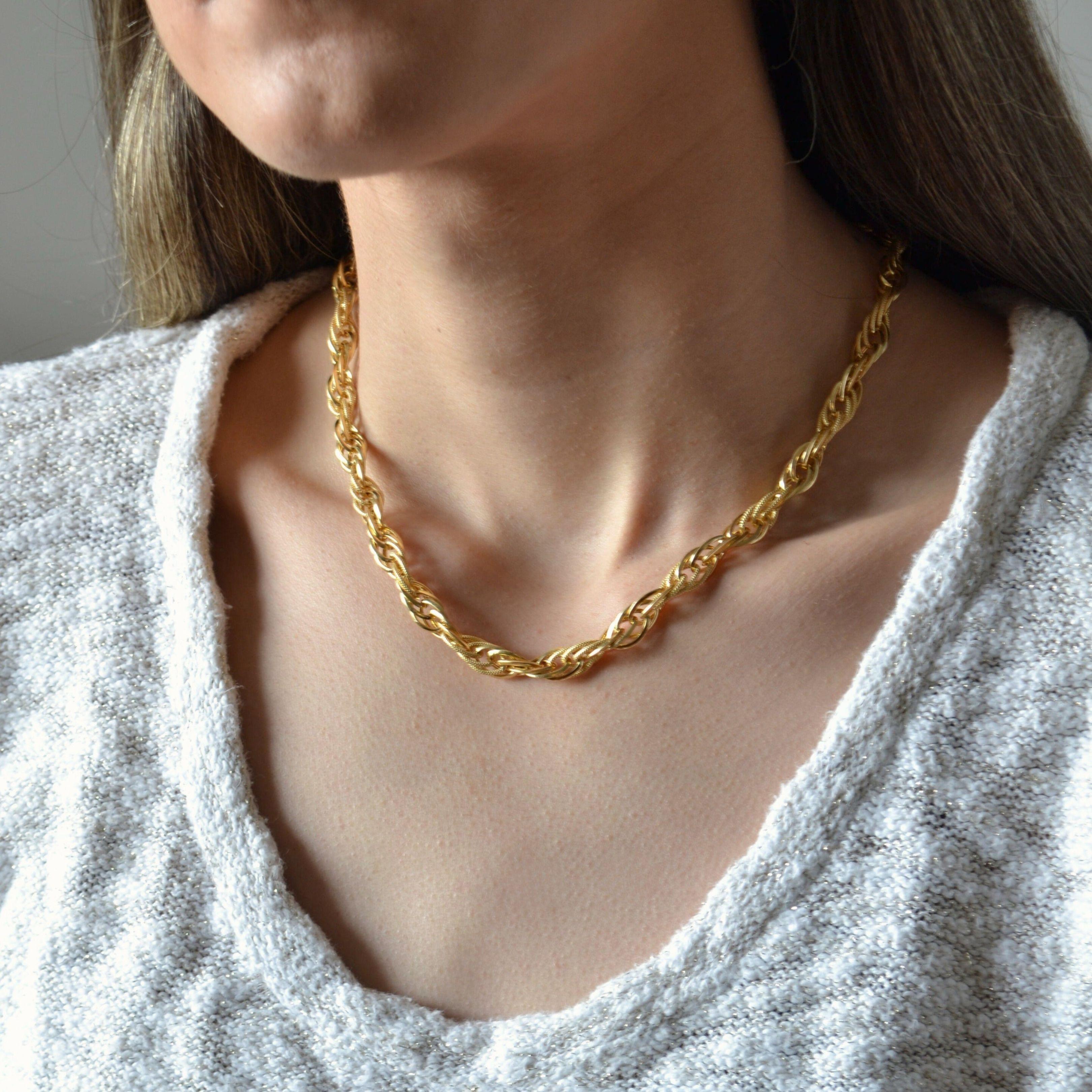 This 18K yellow gold rope chain necklace embodies elegance and sophistication with its intricate braided design. Handcrafted by master artisans in Brazil, each link is meticulously woven to create a luxurious texture that catches the light