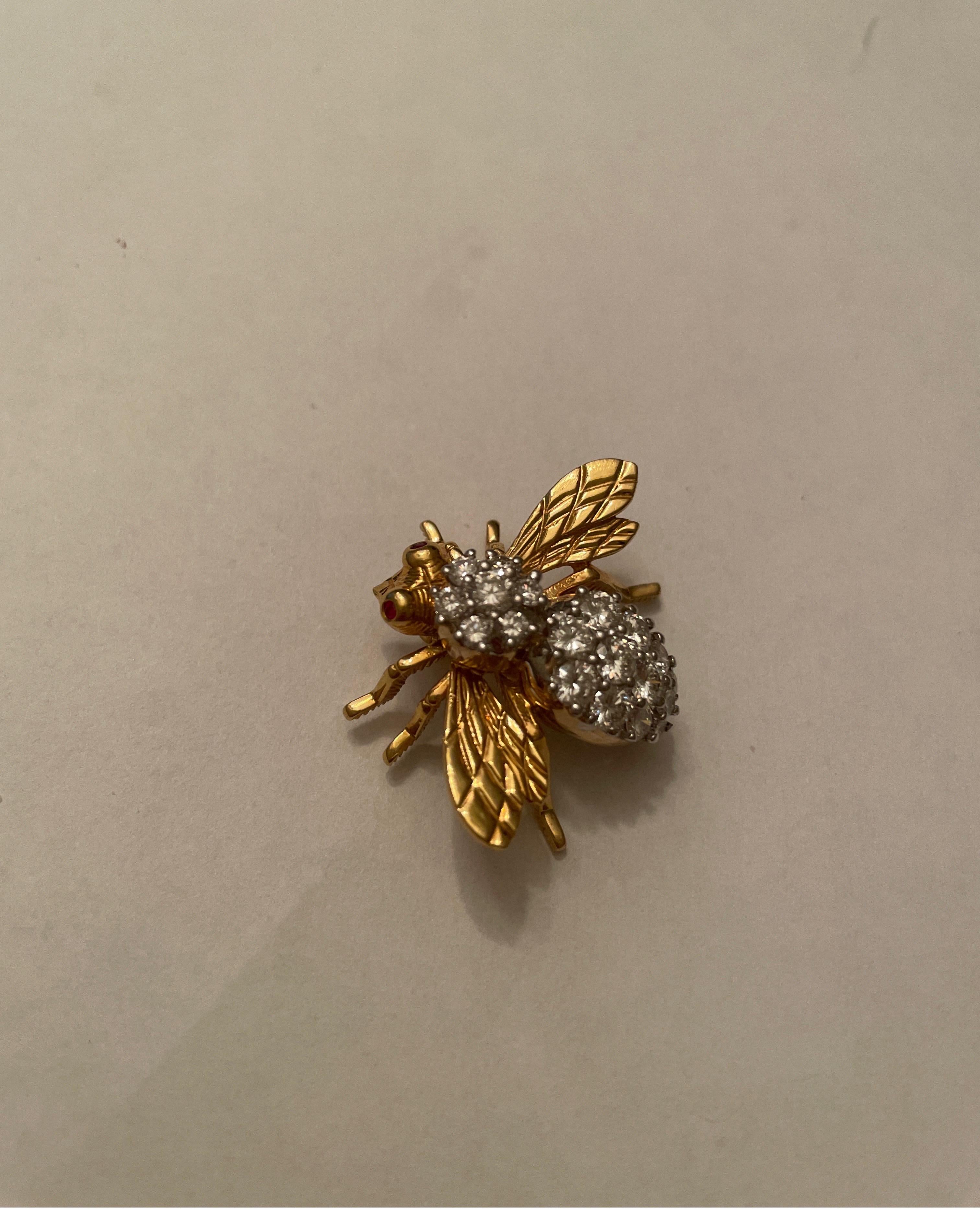 18K yellow gold Rosenthal diamond bee pin,  prong set with 19 full cut round diamonds weighing 1.97cts, and bezel set ruby eyes.
retail $7500