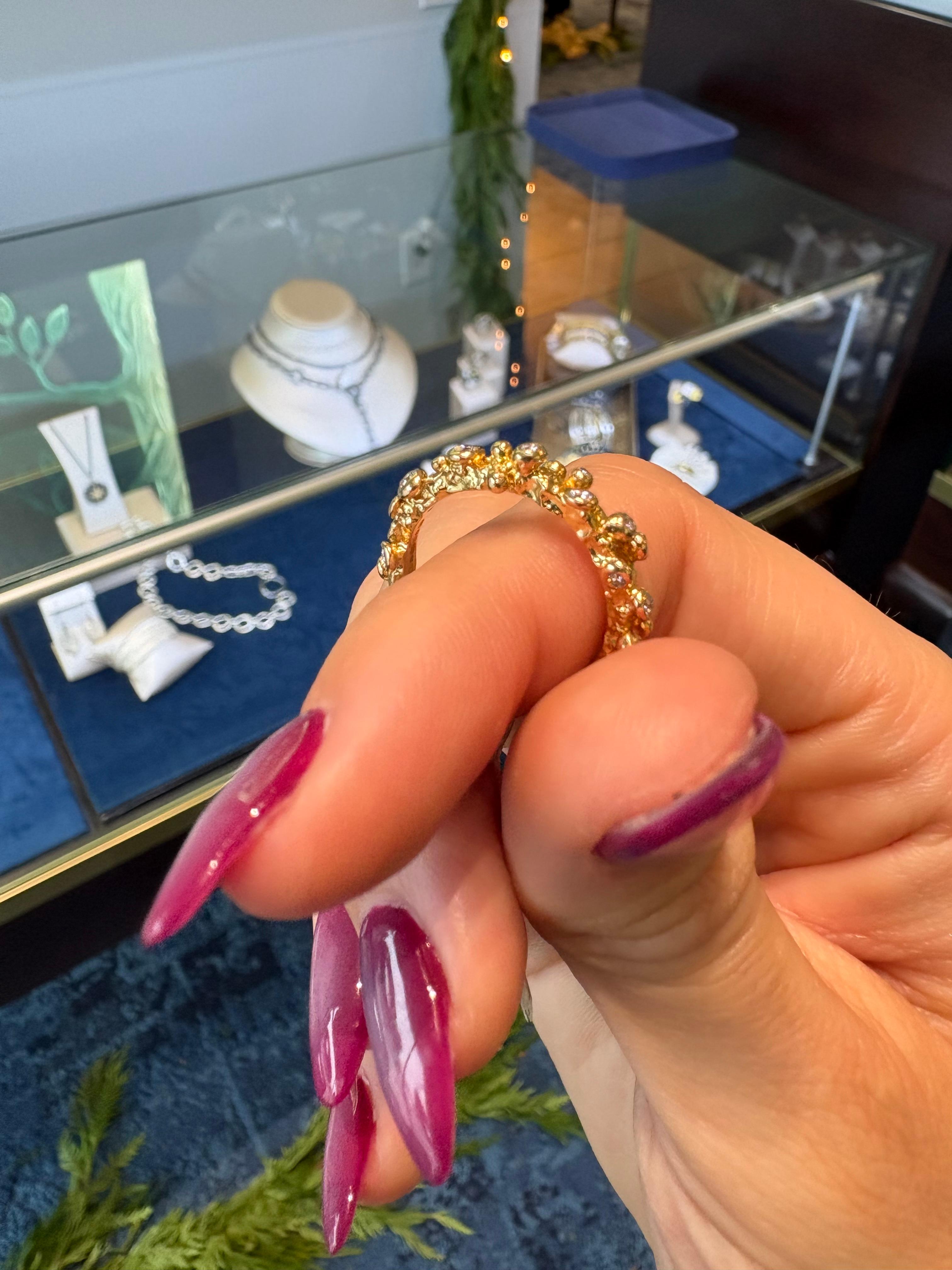 Immerse yourself in a world of refined opulence with this remarkable ring, expertly crafted in radiant 18k yellow gold and adorned with a constellation of 0.38cttw round brilliant-cut diamonds. Its allure unfolds through the intricate, artful