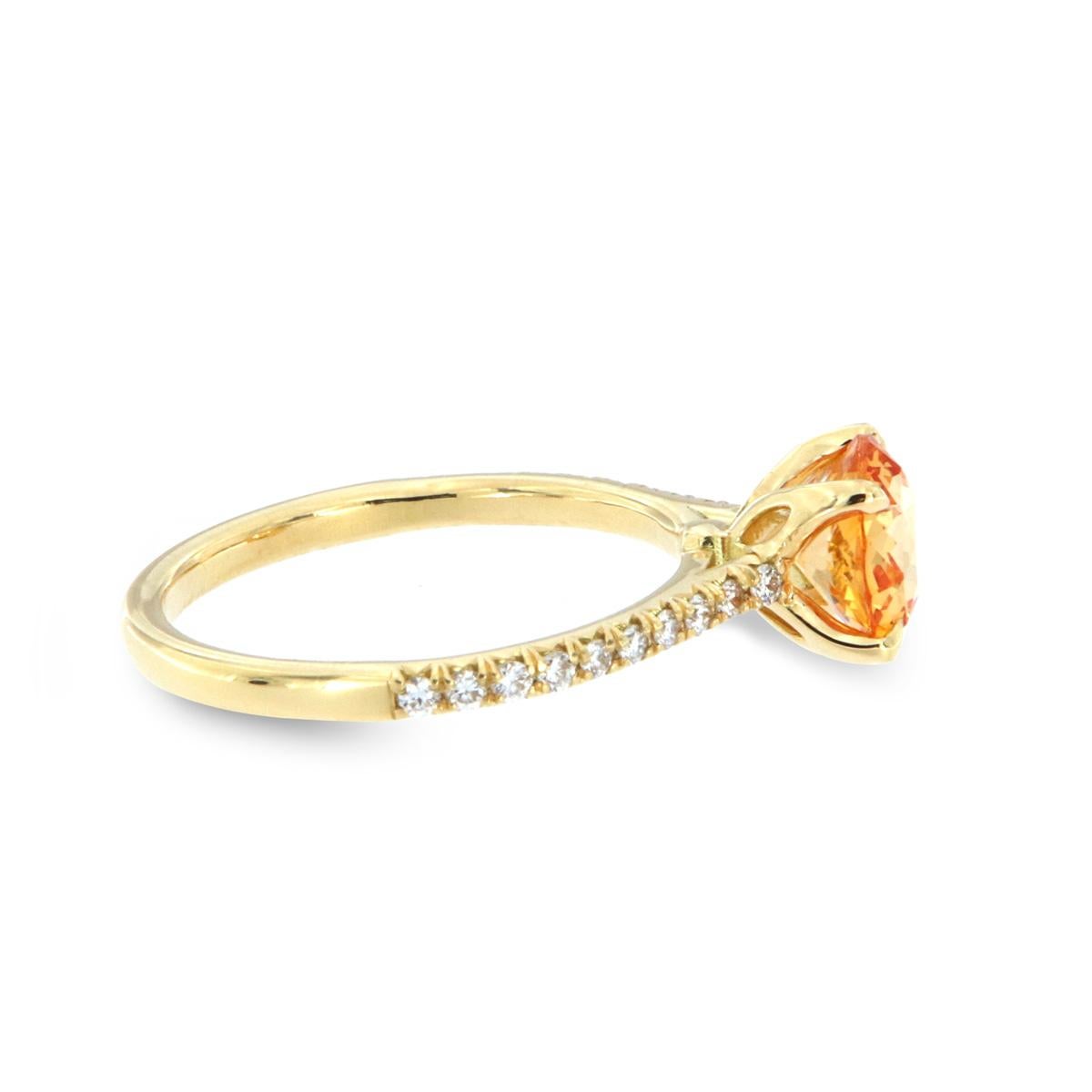 This classic 18K Yellow gold ring features French Pave set diamonds in three-fourths of the band centering a 1.61 carat Orange Sapphire Beryllium Diffused GIA Certificate 2201148708. Twenty brilliant round diamonds in weight of 0.25 Carat. The ring
