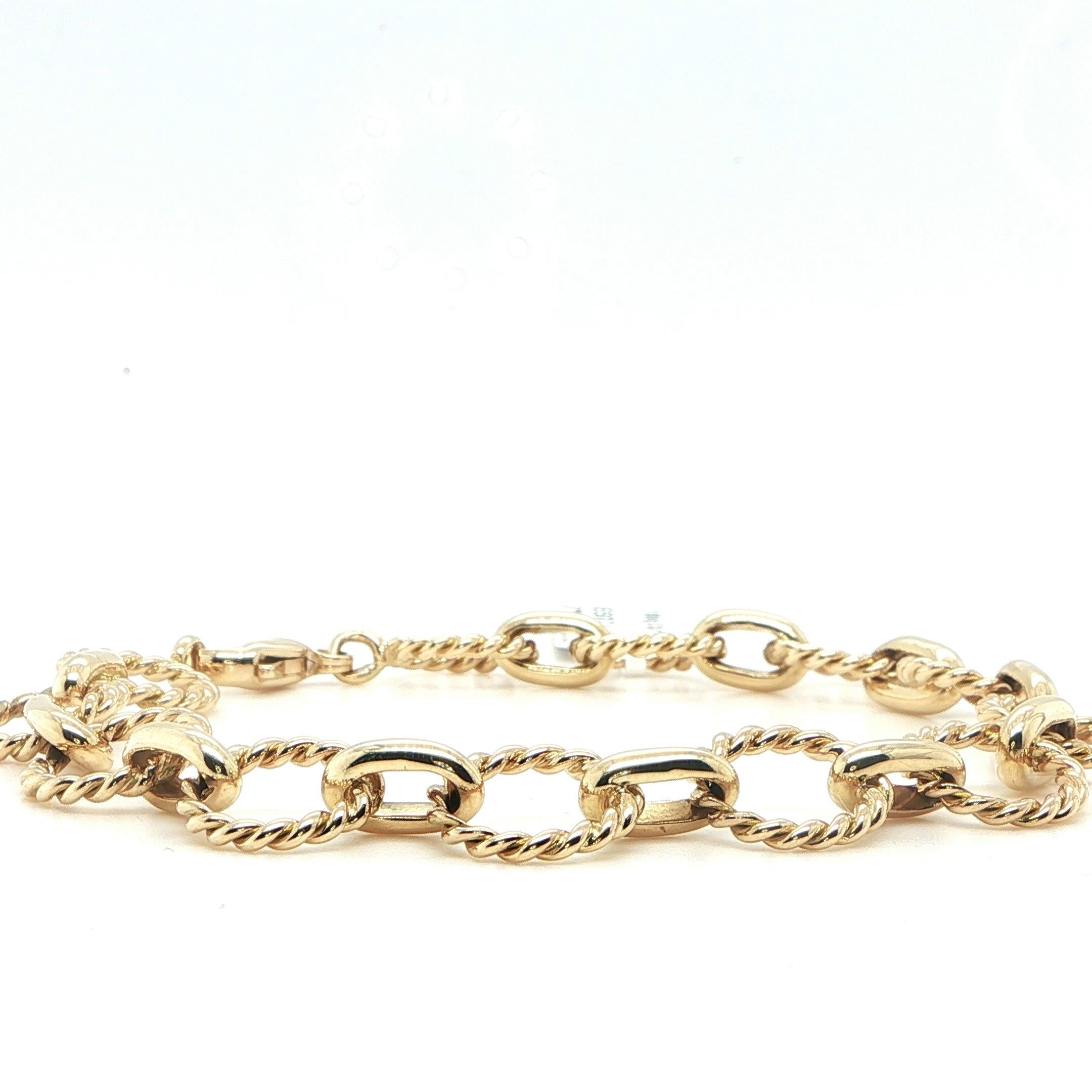 This elegant 18 karat yellow gold bracelet features a striking combination of round and twisted links, each measuring approximately 11mm, creating a bold yet refined look on the wrist. The alternating textures add dimension, movement, and light