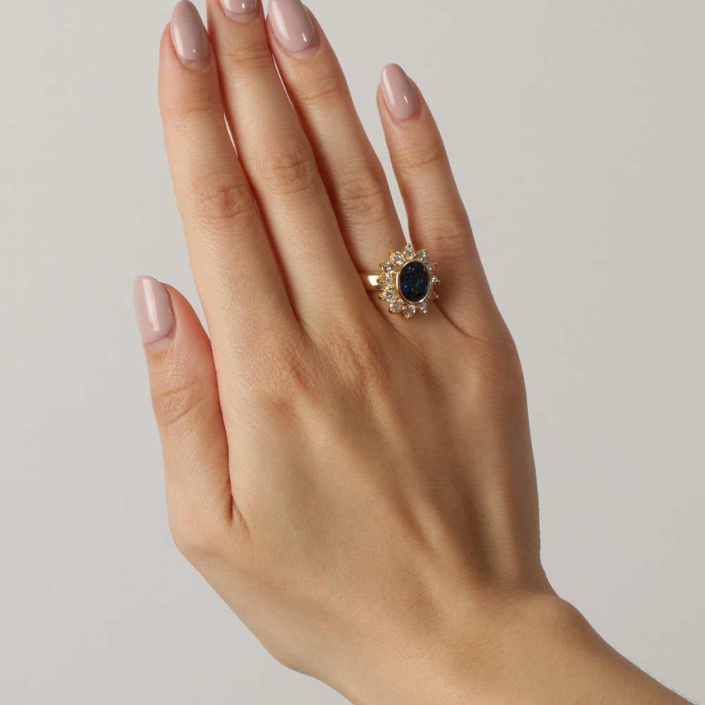Women's Rosette Ring with Diamonds and Sapphire  12x Brilliant-Cut Diamonds (Approx. 1.00 ct, G/VS)  1x Oval Ceylon Sapphire (3.96 ct)  Size 6 (US) / 12(ES) 12  18K Yellow Gold  8.60 grams  Adjustable Size (Consult for Pricing)  Brand New, Never