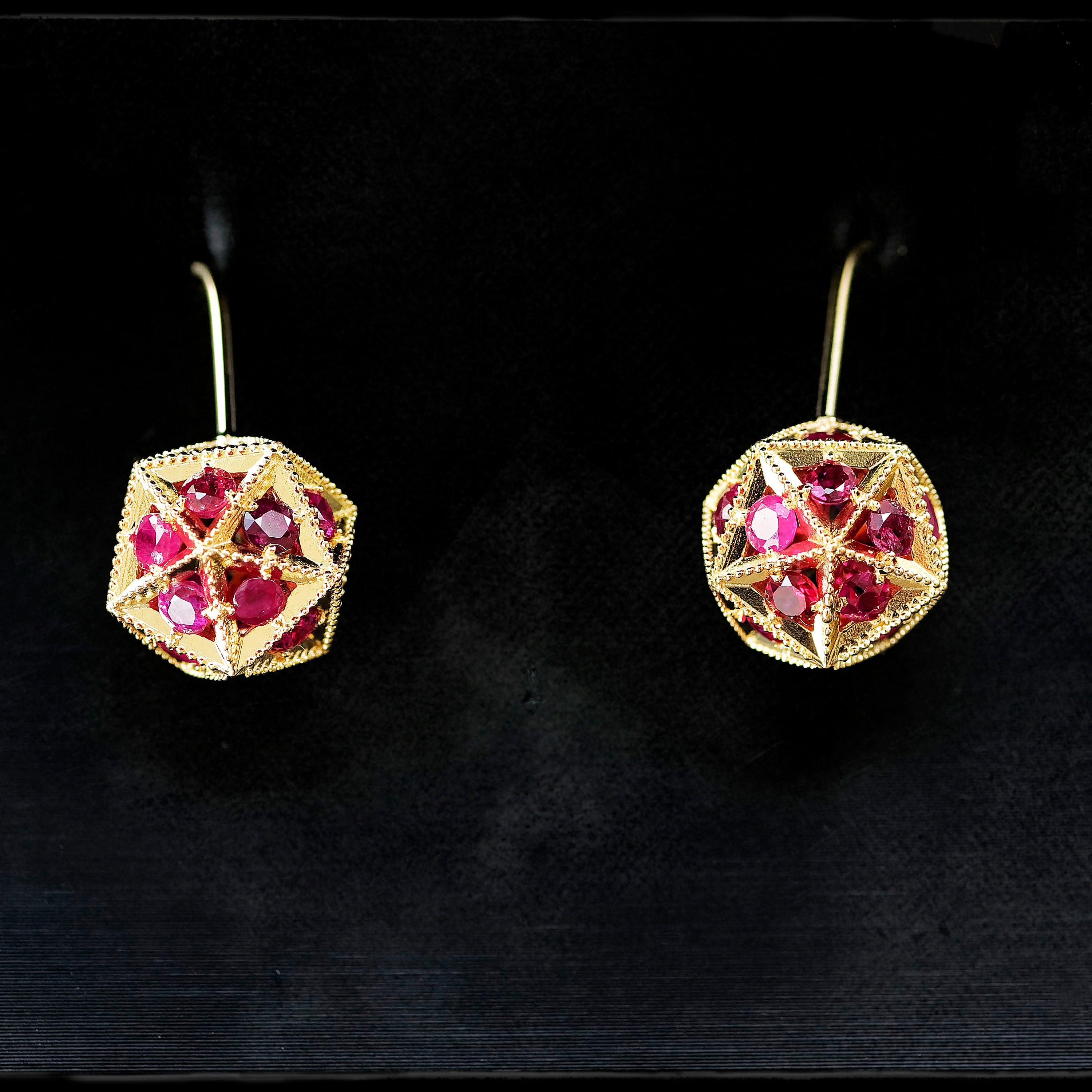 These drop earrings in 18K gold are set with perfectly faceted and clear rubies in a pleasing geometric arrangement. A touch of colour and warmth makes them suitable for everyday luxurious wear. Up close, they resemble floating lights from distant