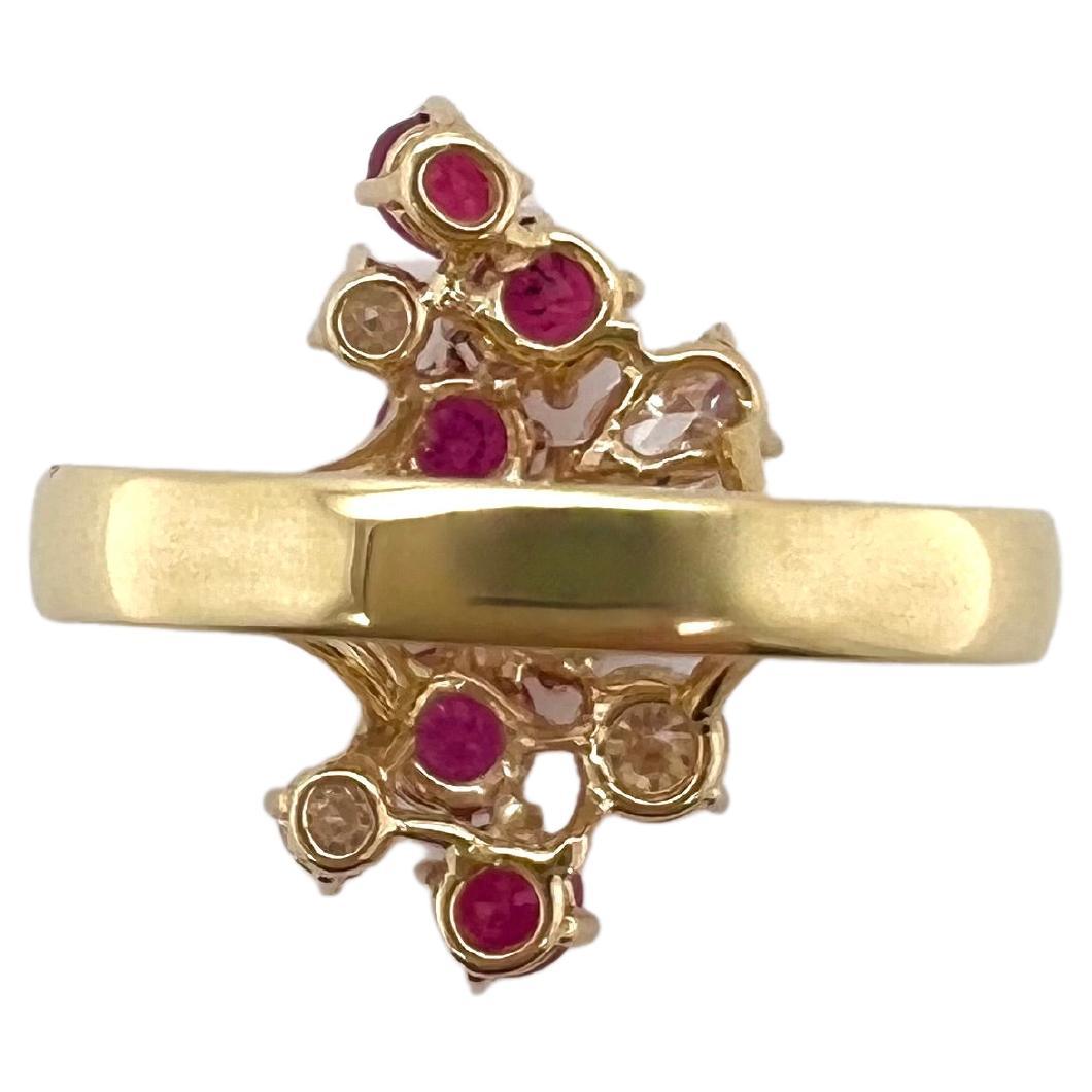 This stunning ruby and diamond cocktail ring is set in 18k yellow gold.  The pear shape and brilliant round diamonds are strategically placed amongst the vibrant rubies.  The yellow gold provides a beautiful contrast which will be perfect to wear