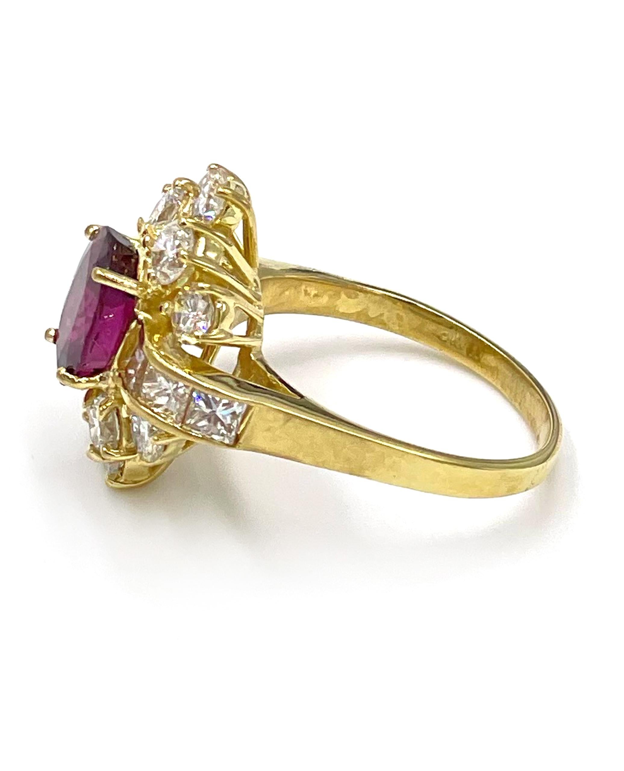 One 18K yellow gold ruby cocktail ring. The ring is furnished with 10 round brilliant-cut diamonds weighing approximately 1.50 carats and 6 princess cut diamonds weighing an approximate weight of 1.00 carats. In the center, there is one EGL