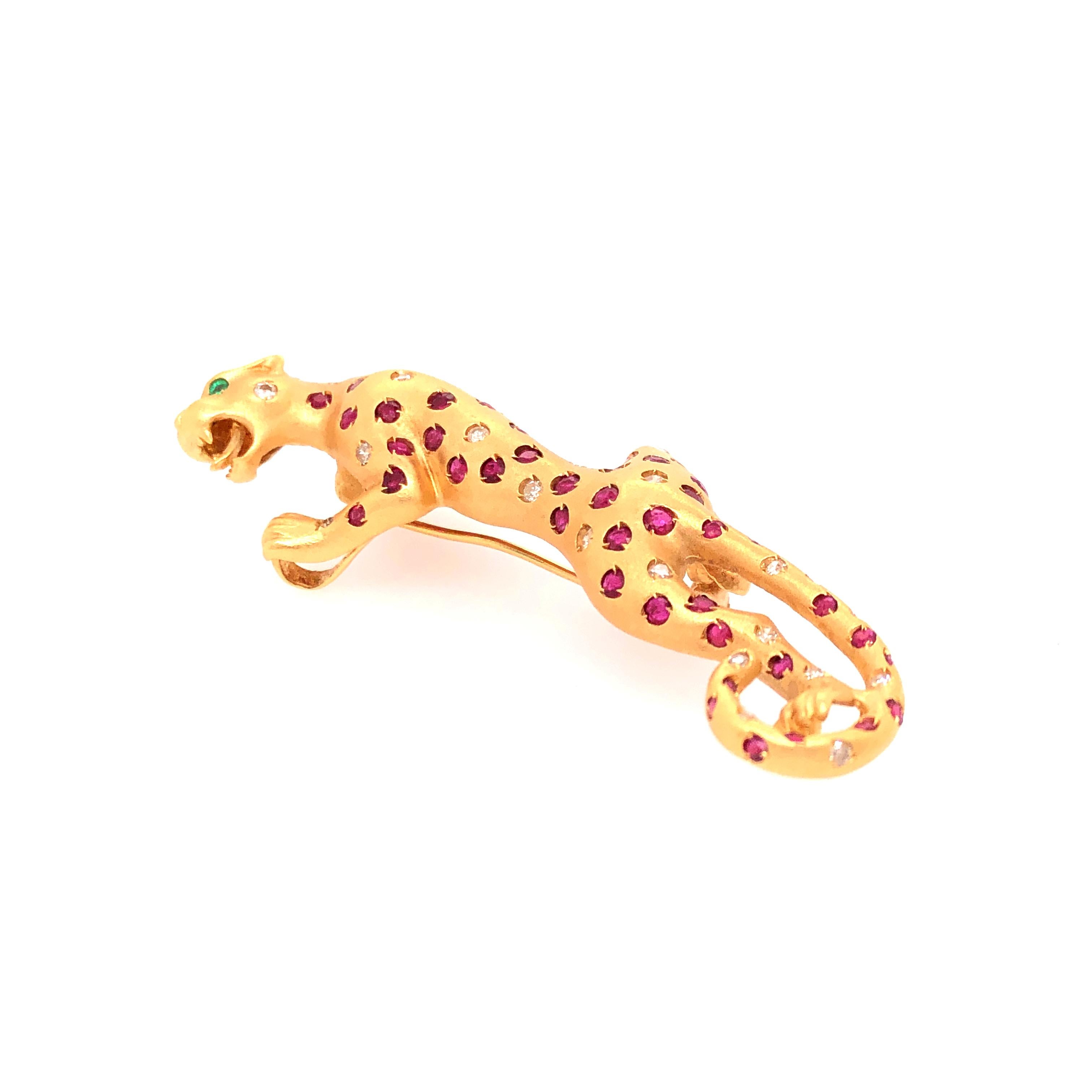 Beautifully sculpted this graceful jaguar can either be worn as a pin or pendant. 1.5mm - 2mm rubies and diamonds make the jaguar's spots. and approximately 1mm emeralds are its eyes. 

From the Skibell Estate Collection

Stamped: 18K, D, 750
