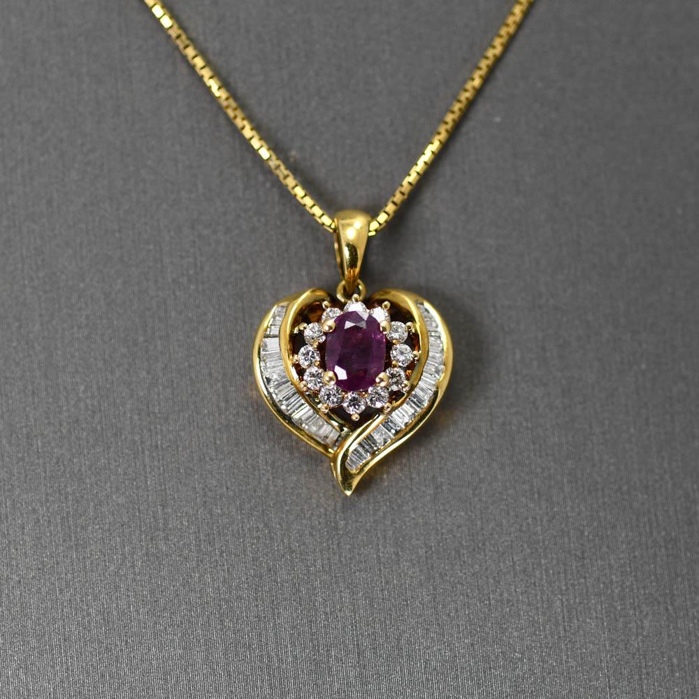 18k Yellow Gold pendant.
The Ruby is a dark Purplish/Red color weighing .75ct.
There are 12 .02ct round Diamonds surrounding the center stone,
with channel-set Baguettes on each side.
There is 1.00tdw between the round and baguette Diamonds.
VS1-SI1
