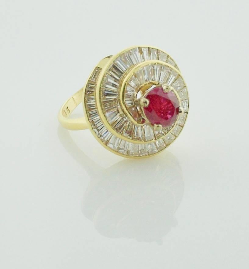 18k Yellow Gold Ruby and Diamond Ring Circa 1970's
A Vibrant Red Oval Ruby weighing 1.38 carats
Channel Set is  Thirty One Tapered Baguette Diamonds weighing 2.75 carats approximately GH VVS-VS1
A Modern Take on The Classic Ballerina Ring

 