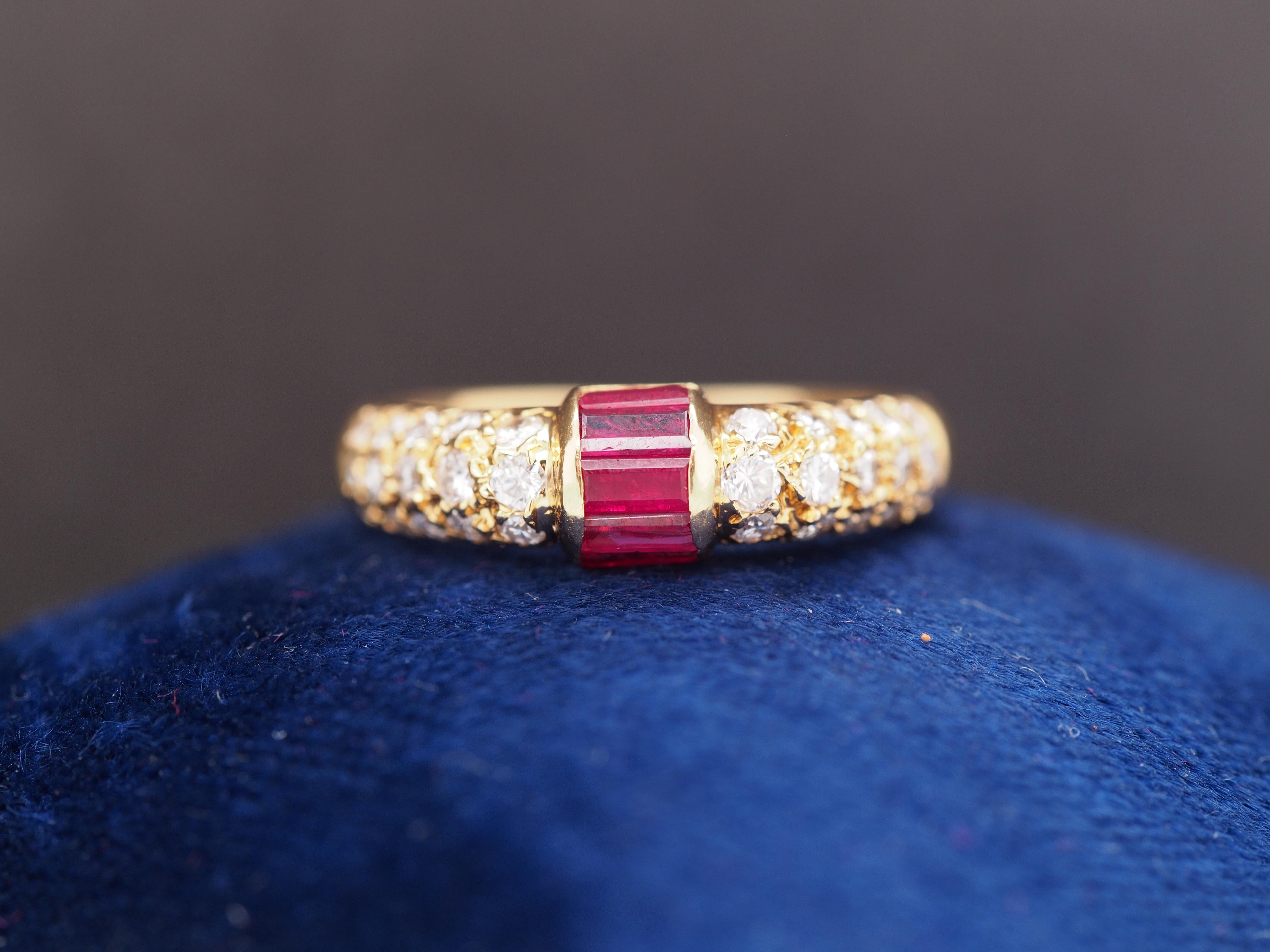 Year: 1990s
Item Details:
Ring Size: 5.75
Metal Type: 18k Yellow Gold [Hallmarked, and Tested]
Weight: 3.1 grams
Diamond and Ruby Details
Center Rubies: Natural, Red, Straight Baguette, .40ct total weight
Side Diamonds: .50ct total weight, F Color,