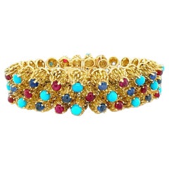 Armband aus 18 Karat Gelbgold mit Rubin, Saphir und Türkis