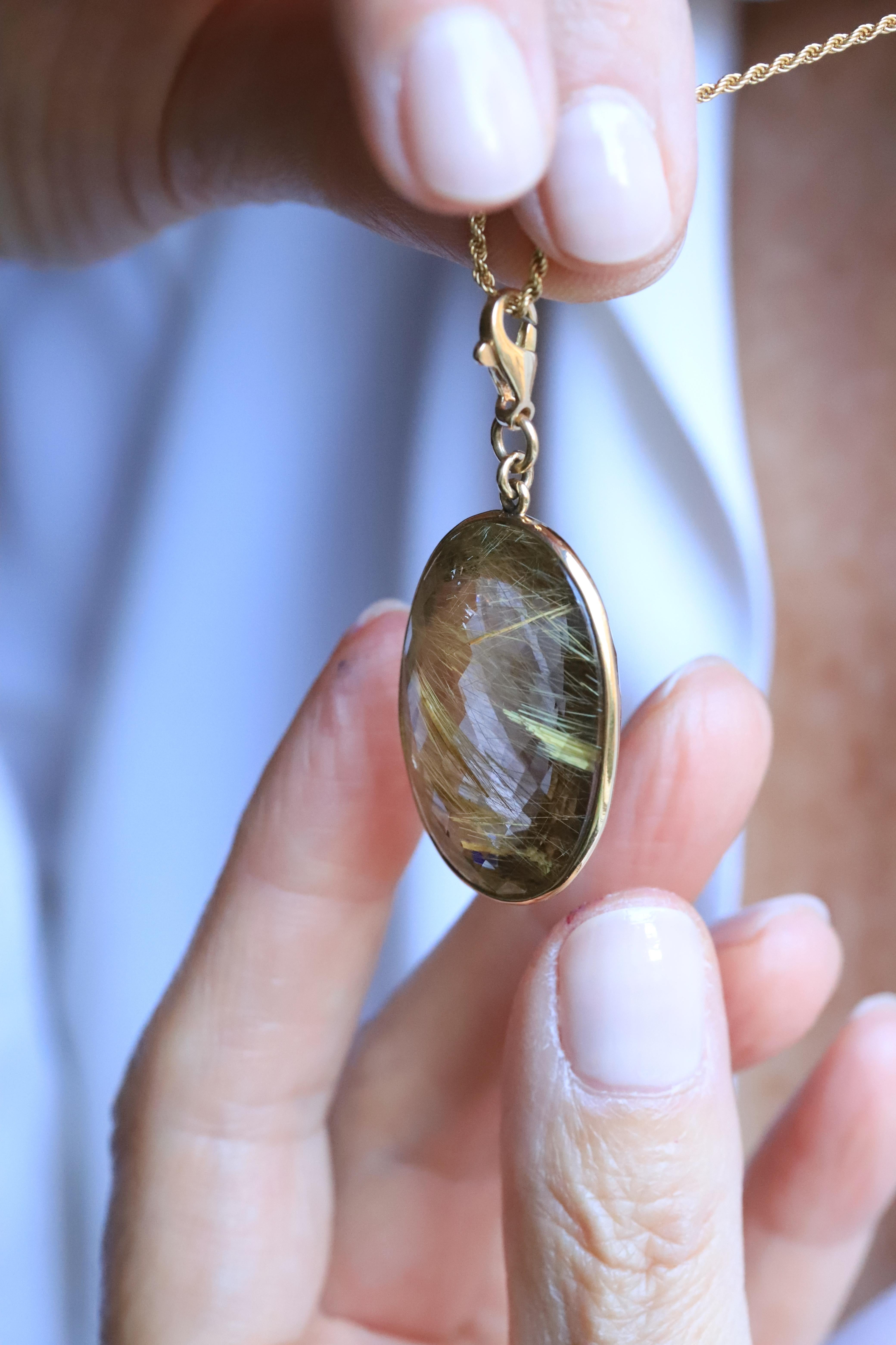 Die fesselnde Rossella Ugolini Design Collection'S stellt den außergewöhnlichen Ovalschliff-Charm aus Rutilquarz vor, der einzigartig ist. Dieser exquisite Anhänger aus 18-karätigem Gelbgold zeigt die bemerkenswerte Schönheit der Kunst der Natur in