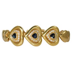 Herzförmiges Armband aus 18 Karat Gelbgold mit Saphiren und Diamanten, 29 g
