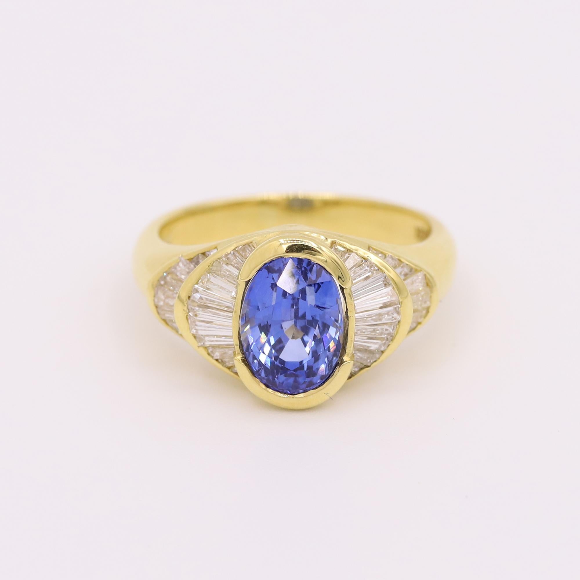 Vintage 18k yellow gold sapphire and diamond ring. The oval sapphire weighs 3.03 ctw. The ring features 40 tapered baguettes weighing 1.10 ctw. The ring size is 6.5 
