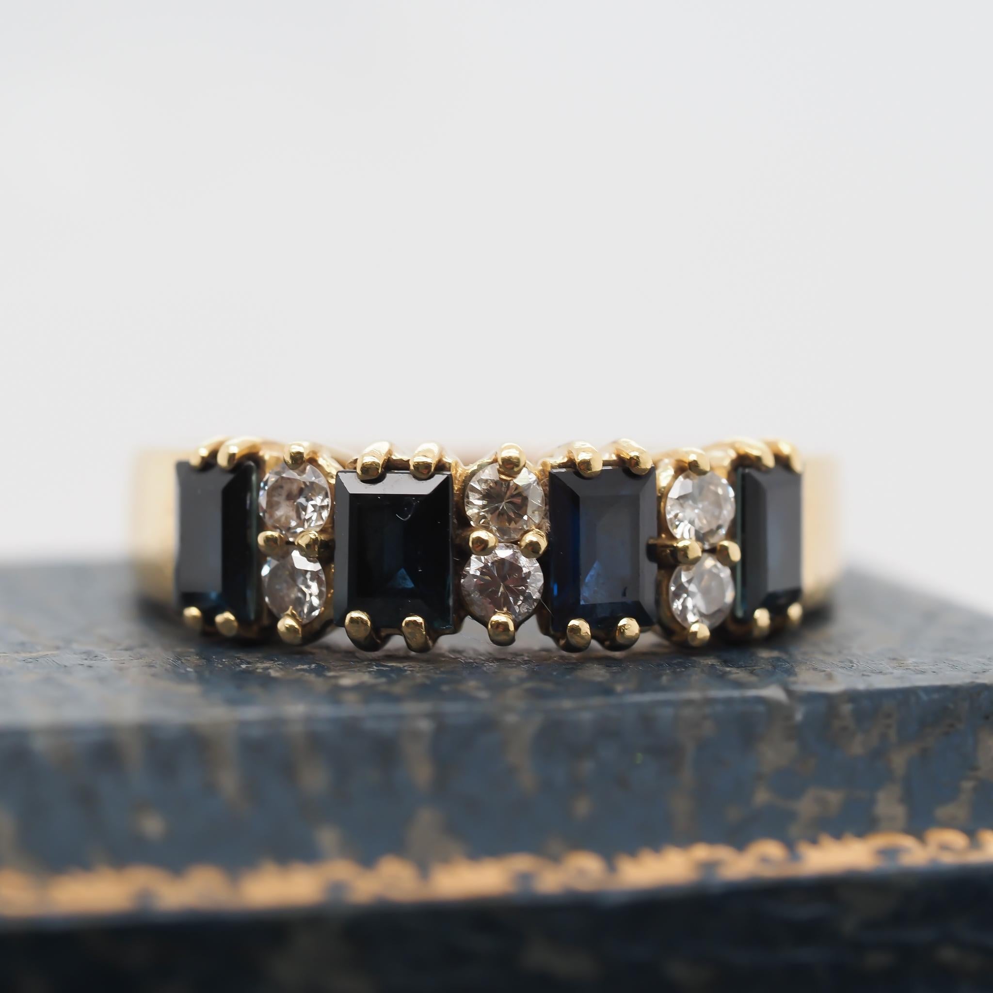 Year: 1990s
Item Details:
Ring Size: 8.5 (Sizable)
Metal Type: 18K Yellow Gold [Hallmarked, and Tested]
Weight: 5.9 grams
Diamond Details: .25ct total weight, G Color, VS Clarity, Natural Diamond, Round Brilliant Cut
Side Stone Details: Sapphire,