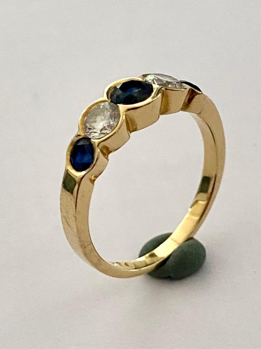 One (1) 18K. Yellow Gold Ring, 5 stones:
3 Natural Coundum, Sapphire  = 1.00 ct. Deep Blue
2 Natural Diamonds, Round Brillant Cut = 0.54 ct.  VS  G-H
Weight: 4.21 gram
Size of the Ring: 17.75  (7.5)  56  (P-)  We can make this Ring on the Size you