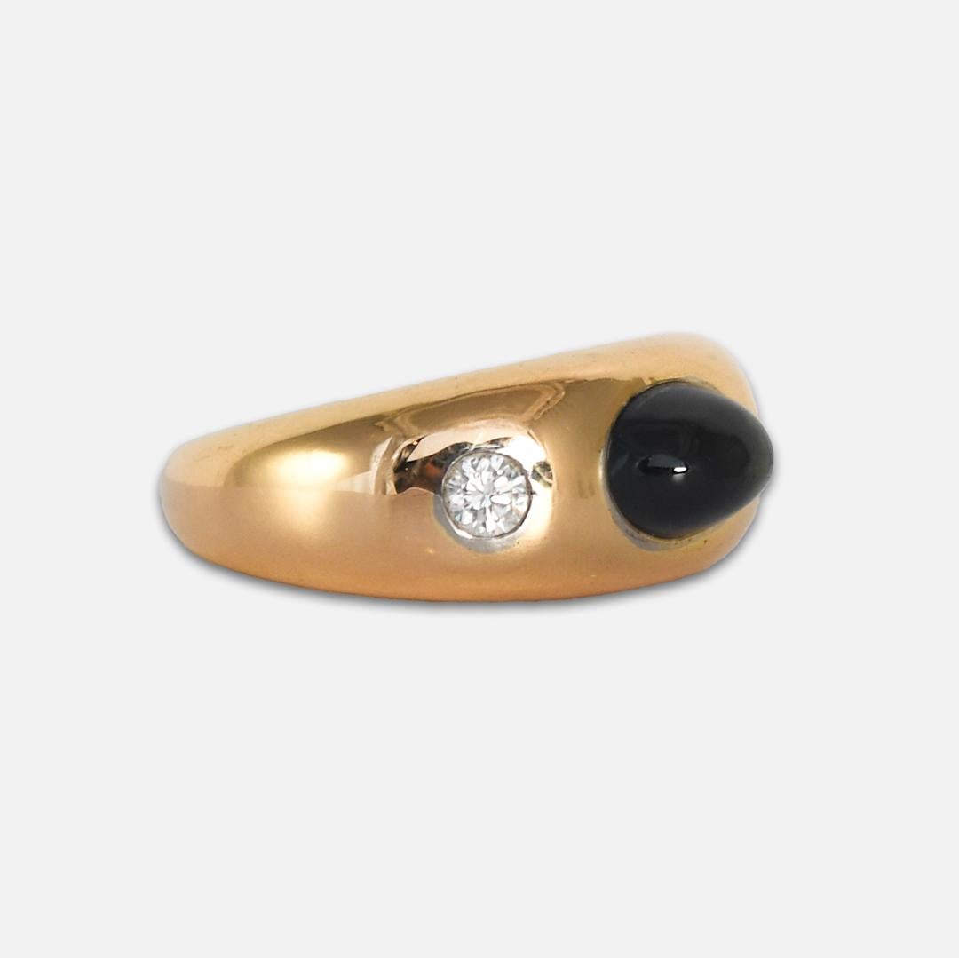 18k yellow gold, sapphire, and diamond ring.
Stamped 18k and tests 76% gold with an XRF analyzer.
The ring weighs 19 grams gross weight. 
The blue sapphire is a high-quality cabochon cut, 9.2 x6.4 x 5.2mm, approximately 3.20 carat.
The side diamonds