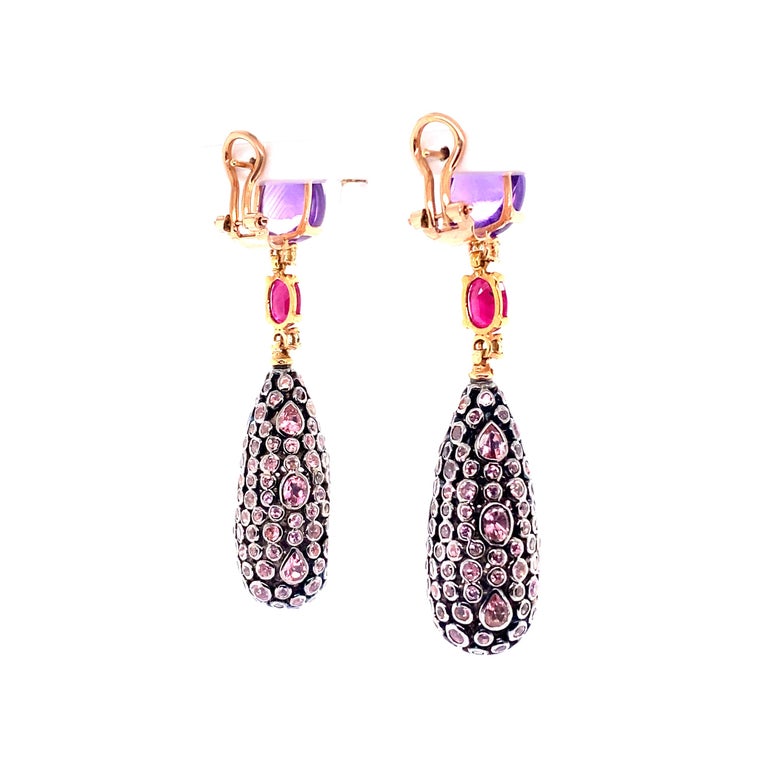 Sapphire Ruby and Tourmaline 18K Yellow Gold Pendant Earrings 

Amethyst cabochon size width 1 cm and length 1 cm 
Ruby cabochon width 0.5 cm and length 0.6 cm 
Sapphire brilliant cut 
Tourmaline set in lace of various shapes 