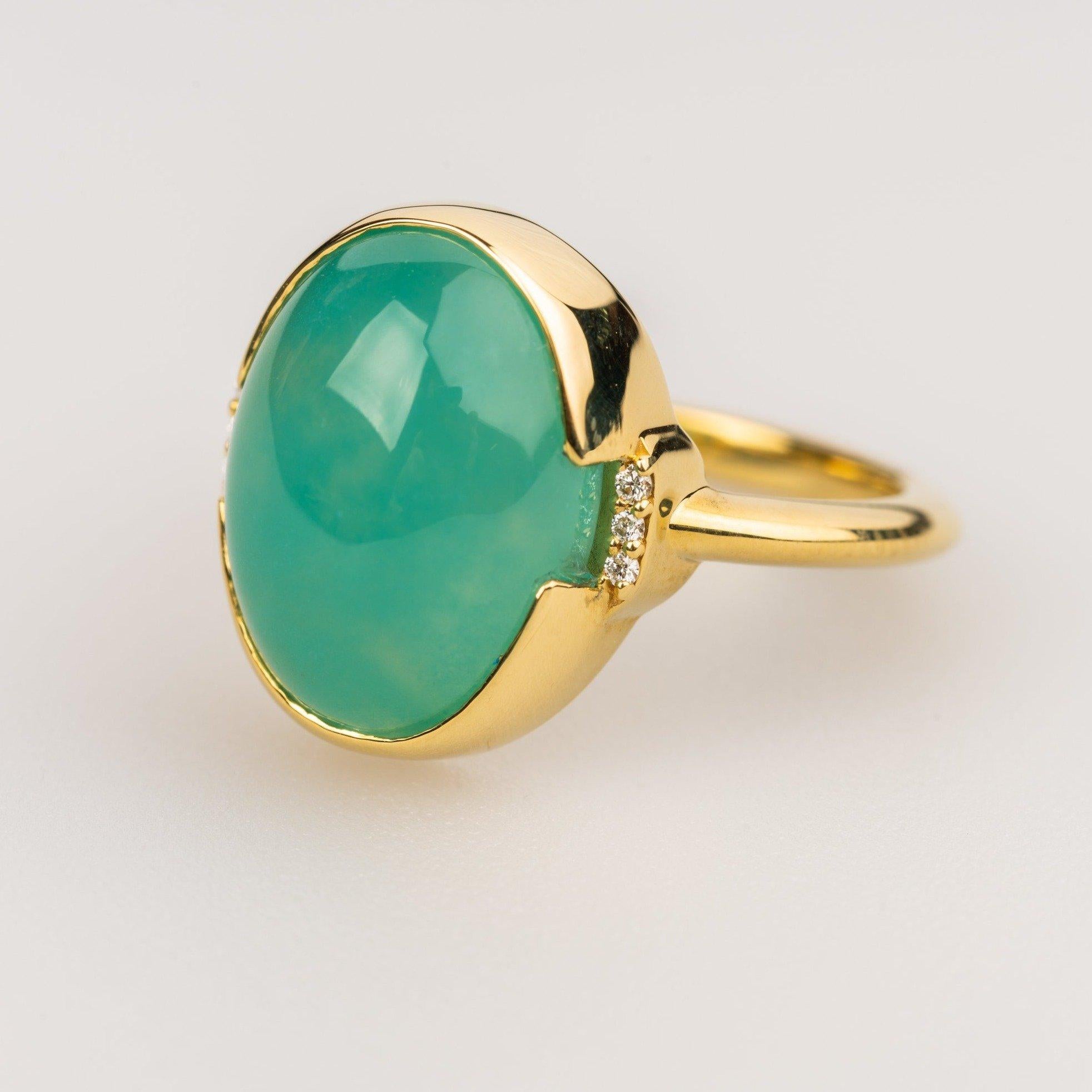 An 18k Yellow Gold Ring set with a 7.61 carat seafoam chalcedony and .03 carat F color VS clarity white diamonds. Ring size 6.5. This ring was made and designed by Sydney Strong.