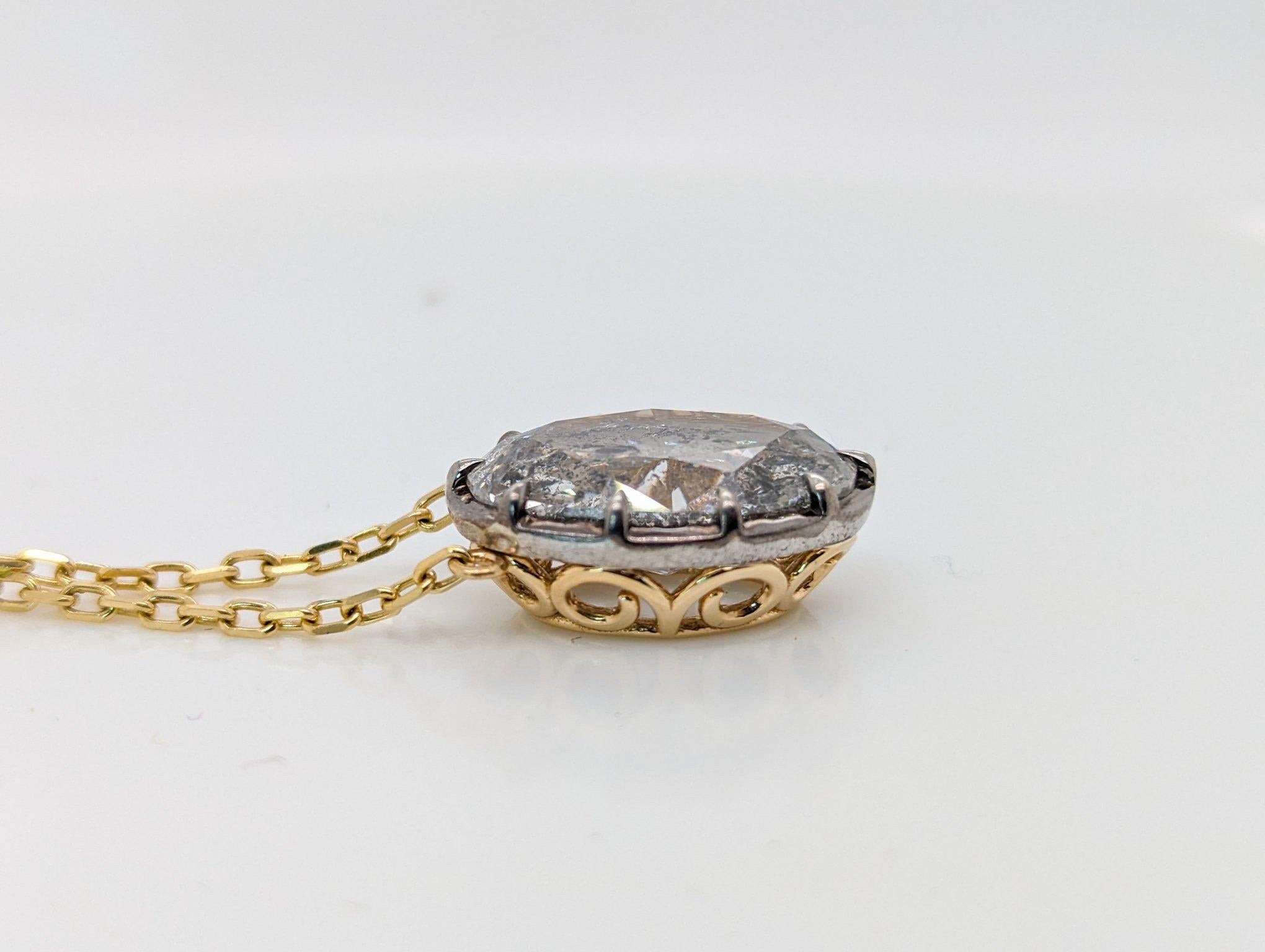 This pendant is our very own Georgian-inspired design featuring a sparkling 7.66 carat diamond set in 18K yellow gold and sterling silver. 