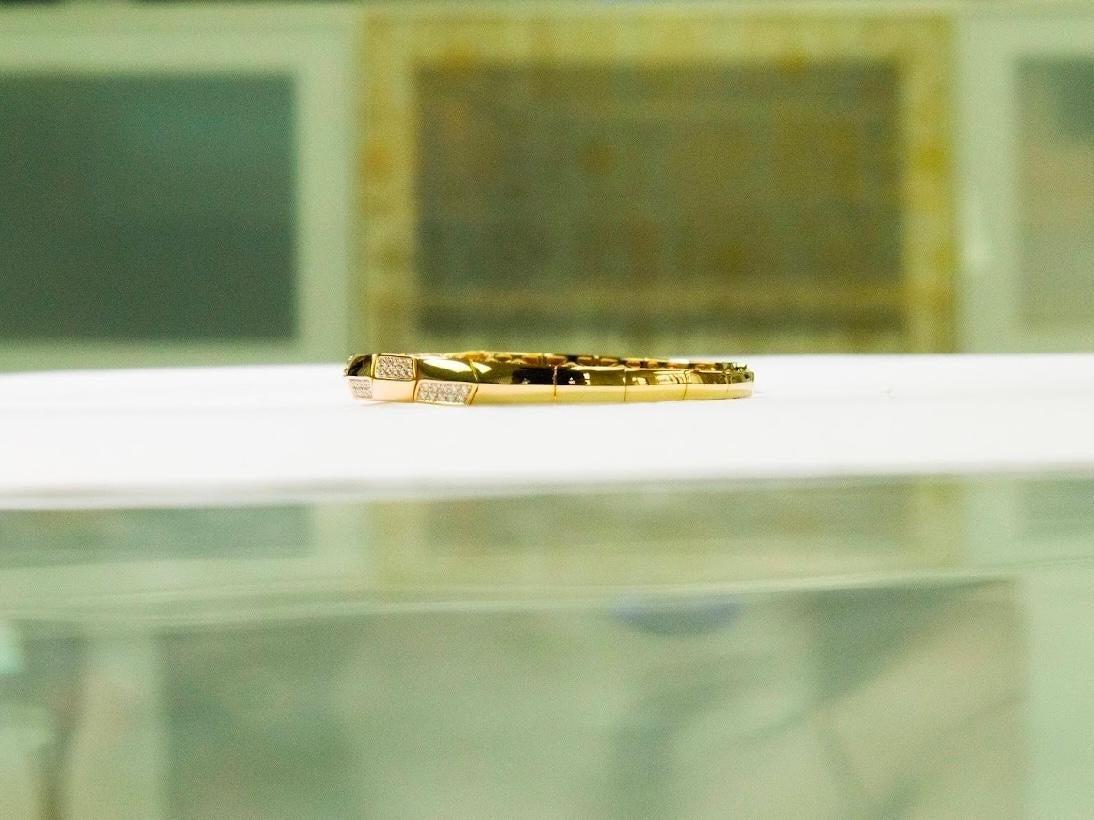 •	Metal: 18K Yellow Gold
•	Weight: 9.62gm 
•	Gemstones: Natural Diamonds
•	Total Diamond Weight: 0.57 ct (80 stones)
•       Diameter of bracelet: 1.8 inch - 2.3 inch

Inspired by the essence of renewal and grace, this exquisite bangle is crafted