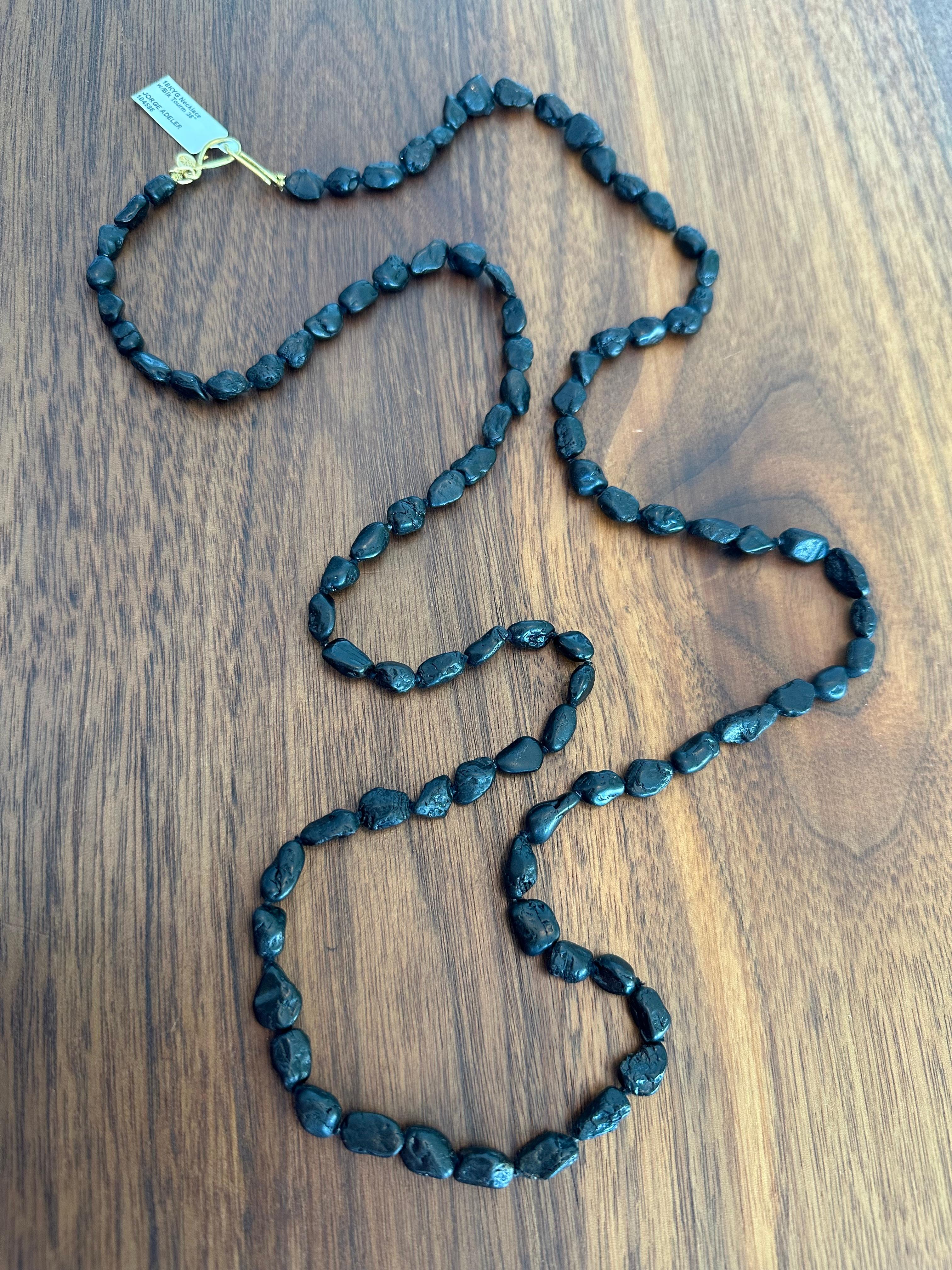 Sculptural and soulful, this 38-inch necklace by Jorge Adeler features 293 carats of hand-selected black tourmaline paired with natural 18k yellow gold nuggets, creating a seamless fusion of rugged beauty and luxury.

Each tourmaline bead retains
