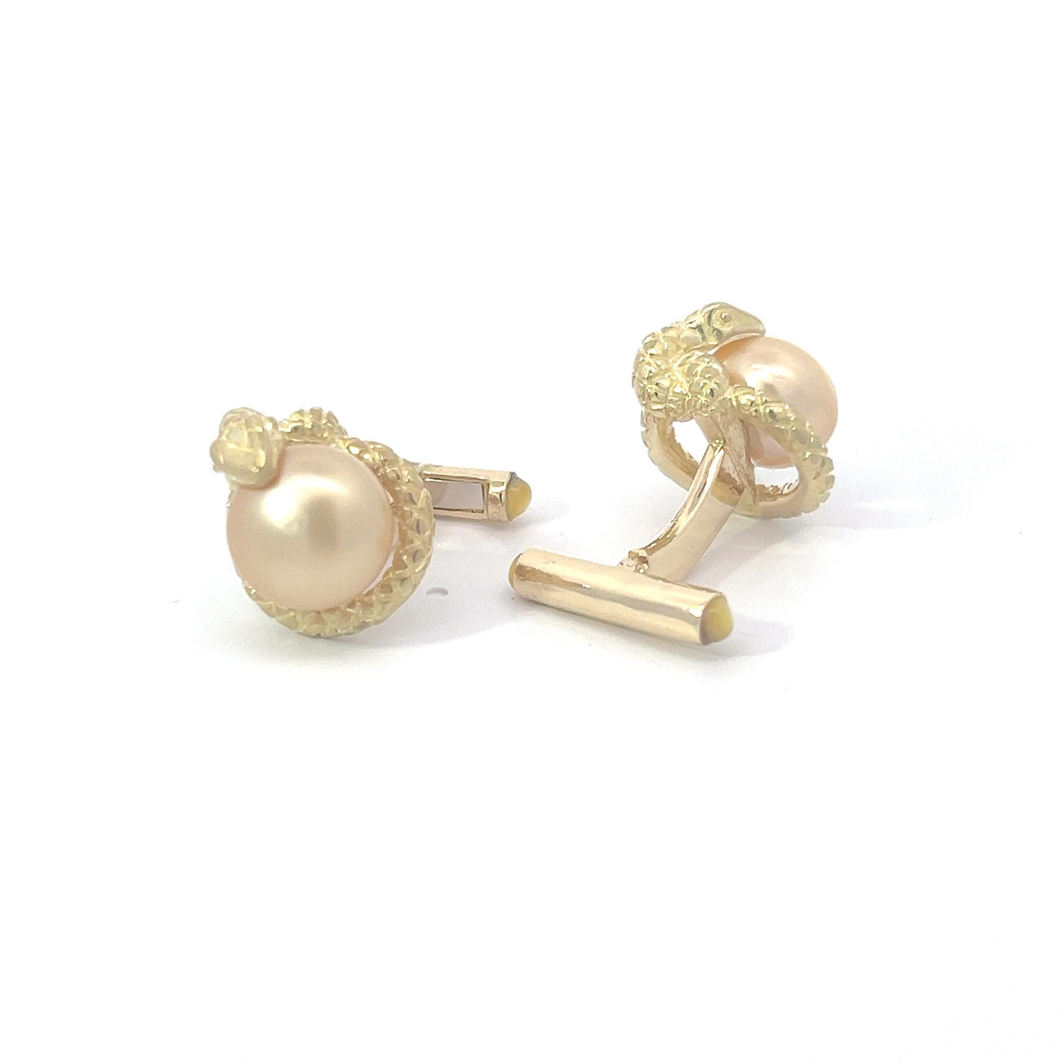 Presenting a pair of cufflinks that exude opulence and refinement, crafted in radiant 18k yellow gold. At the forefront of each cufflink, gleaming like treasures from the depths of the ocean, are luminous yellow South Sea pearls. These pearls,