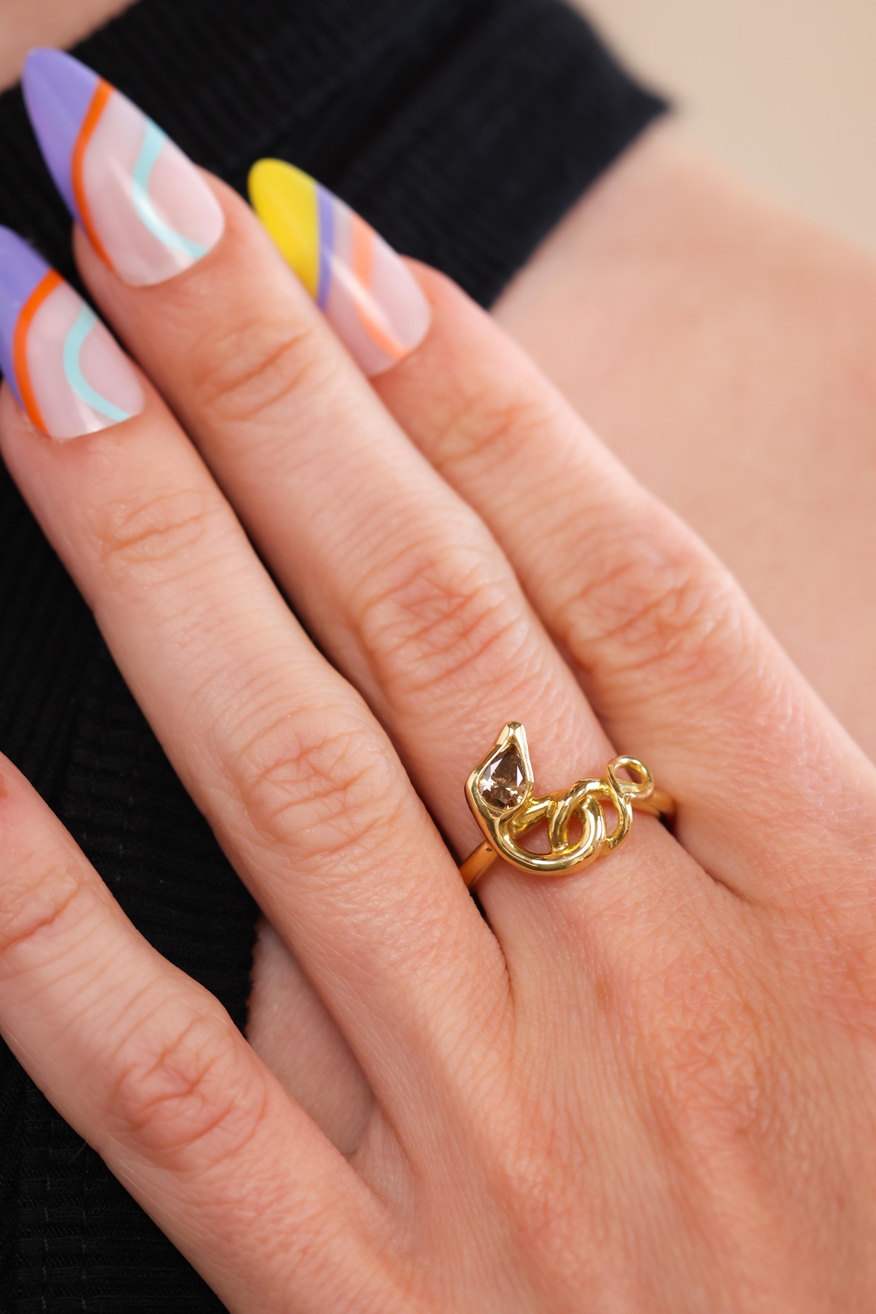 This is Trumpet & Horn’s take on the ever popular snake ring reminiscent of the Victorian era featuring a champagne diamond. The 18k yellow gold ring is a modern twist on an ancient design, most notably a trend set by Queen Victoria after Prince